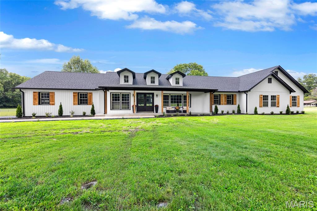 Welcome to 4733 Fox Creek Road. Nestled on a picturesque level lot, this completely reimagined 4 bedroom, 3.5 bath residence blends modern luxury with timeless craftsmanship. Fully renovated inside and out, the home offers extensive updates including new electrical, plumbing, flooring, cabinetry and a thoughtfully designed addition, expanding your finished living to approximately 2,400 square feet. Impressive curb appeal including a covered porch and a stunning dual craftsman style door welcomes you into the spacious great room featuring engineered hardwood flooring, wood-beamed ceiling open to dormer window views and a cozy fireplace. The heart of the home is the designer kitchen, showcasing custom cabinetry, quartz countertops, tiled backsplash, expansive center island, custom wood range hood and a butlers pantry, all opening seamlessly to the dining room and great room for effortless entertaining. The luxurious primary suite offers a private retreat with double door entry, walk-in closets, fireplace and a spa inspired ensuite bath featuring dual vanities, soaking tub, rainfall shower and separate water closet. Two additional guest bedrooms, including one with an ensuite bath, provide comfortable accommodations, while a flexible office space or fourth bedroom offers versatility for today's lifestyle. Outside, the extensive exterior renovation includes board and batten style vinyl siding, decorative wood shutters and wood accents, covered front porch, triple dormers, upgraded landscaping and fresh concrete walkways. Relax on the covered rear patio overlooking the serene, tree lined backyard. Additional highlights include an oversized two car garage with backyard access, large main floor laundry, dual-zoned HVAC systems and water softener. A rare opportunity to own on 3 beautiful acres within the municipality of Wildwood! Rockwood School District.