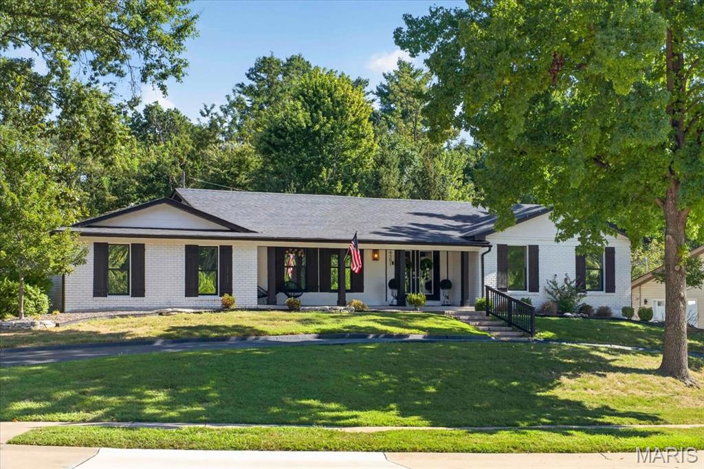 Welcome to 14391 Ladue Road, a spacious Chesterfield ranch offering over 6,000 sq. ft. of total living space on a .579-acre corner lot. This 4-bedroom, 3-bath home features an open floor plan, wood flooring, dining space, and an inviting family room with a newly installed fireplace box. The kitchen offers a large center island, solid-surface countertops, gas cooking, and plenty of space for gathering, complemented by a newly added wine and beverage center just off the kitchen. All four bedrooms are conveniently located on the main level, including an impressive 26' x 16' primary suite featuring a custom-built closet. Two additional bedrooms also offer custom closet systems. The main-level laundry has been enhanced with custom shelving and cabinetry for added storage and organization. Additional improvements include a new A/C unit and heater. The partially finished lower level provides even more versatility with a large recreation room, hearth area, sleeping area, workshop/hobby space, storage, and a third full bath. Outside, enjoy the large, level lot with upgraded backyard landscaping and a designated fire pit area, perfect for relaxing or entertaining. An attached 2-car garage plus two additional spaces in the detached garage provide exceptional parking and storage. An incredible combination of space, thoughtful upgrades, and flexibility in a desirable Chesterfield location!