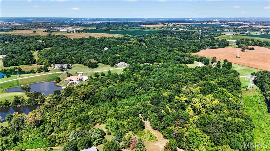 Discover your private retreat in this Country Estates subdivision, featuring 6 acres of pristine, wooded terrain with some cleared. This exceptional property offers the perfect blend of seclusion and recreation, with prime hunting grounds right in your backyard and stunning, serene views of the lake. Located within the highly sought-after Columbia School District, this parcel provides an ideal canvas for your custom dream home in a quiet, rural setting. Electric available at lot line. Private sewer and private well will be needed. Beautiful piece of land!