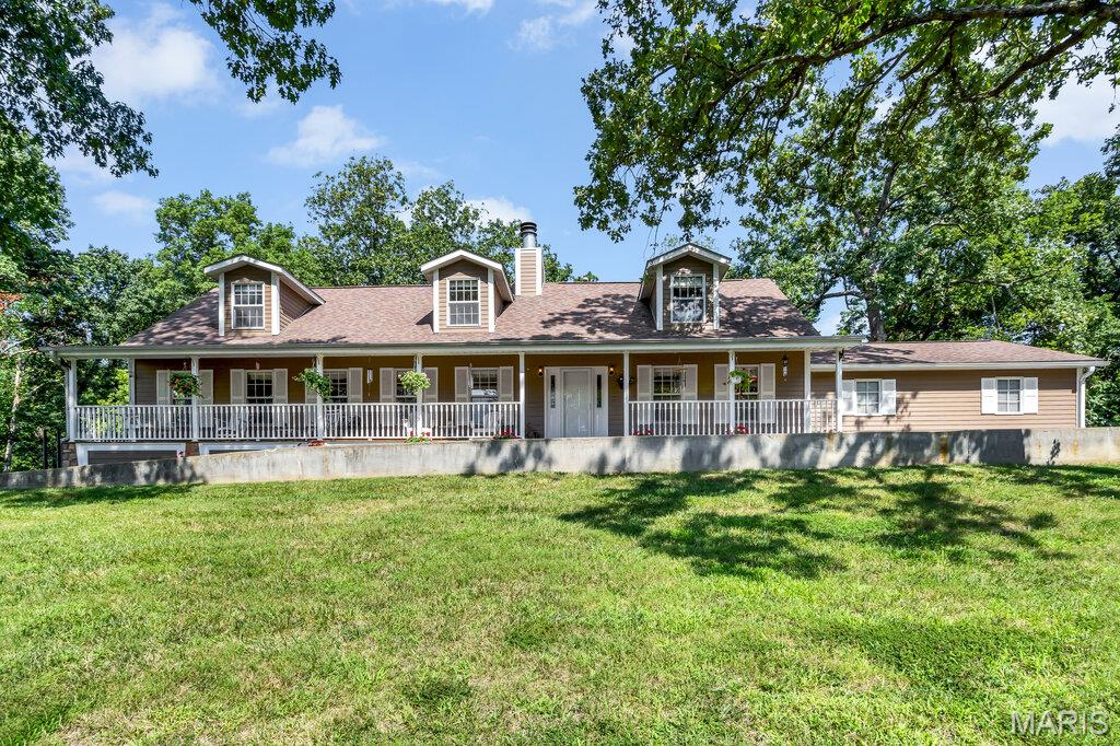 A once-in-a-generation opportunity in Columbia School District. Properties offering this much land, privacy, and natural beauty are extraordinarily rare, making this nearly 18-acre estate one of the most exceptional offerings to hit the market in years. Surrounded by mature trees, rolling meadows, and your own private stocked lake, this remarkable property delivers the peaceful lifestyle so many dream about but rarely find in Columbia. Enjoy coffee on the full-length covered front porch, relax in the hot tub overlooking the woods, fish from the dock, or watch abundant wildlife roam the property. Multiple clearings throughout the acreage offer endless possibilities for gardens, recreation, hunting, trails, or simply enjoying the serenity of your private retreat. Great location, minutes from Columbia - 1st house on the road. 

The impressive story-and-a-half home was designed to embrace its picturesque surroundings. A formal entry hall and stunning staircase welcome guests into expansive open-concept living spaces. The 34' x 16' great room combines living and family areas around a beautiful stone fireplace, creating the perfect gathering space with sweeping views of the property. Bruce hardwood flooring, custom millwork, solid wood doors, and Pella windows showcase the home's exceptional craftsmanship. The spacious dining room and bar area are ideal for entertaining, while the well-appointed kitchen features granite countertops, maple Nauman 42-inch cabinetry, a stainless double sink, dishwasher, and a generous breakfast area.

The main level also includes a conforming bedroom currently used as an office, a full bath, a functional laundry and mudroom with pantry storage, and an insulated attached garage. Upstairs, spacious secondary bedrooms offer dormers, abundant storage, and oversized closets. The owner's suite serves as a private retreat with a large walk-in closet, double vanity, soaking tub, makeup station, and ceramic tile bath.

The finished lower level expands the living space with luxury vinyl plank flooring, office space, family and recreation rooms, a full kitchenette, additional full bath, and extensive storage. A separate climate-controlled basement area with a secure 6' x 6' concrete and steel vault provides endless possibilities for hobbies, collections, a workshop, studio, or specialized storage.

Outside, amenities continue with a detached insulated and heated 40' x 25' workshop, an additional 40' x 15' lean-to, concrete driveway, full-length front porch, 900-square-foot rear deck, Hardie Board siding, fiberglass shingles, fenced yard, dock, security system, and a filled woodshed. The property includes ownership of the entire approximately 12-foot-deep stocked lake, providing year-round recreation and a stunning backdrop. With room for horses or chickens, fountain water for household use, and well water for irrigation and outdoor needs, this property combines luxury, practicality, and self-sufficiency. Opportunities to own nearly 18 pristine acres, a private lake, multiple outbuildings, and a beautifully maintained home in Columbia School District are exceedingly rare.

More than a home, this is a private estate, a nature retreat, and a legacy property all in one.