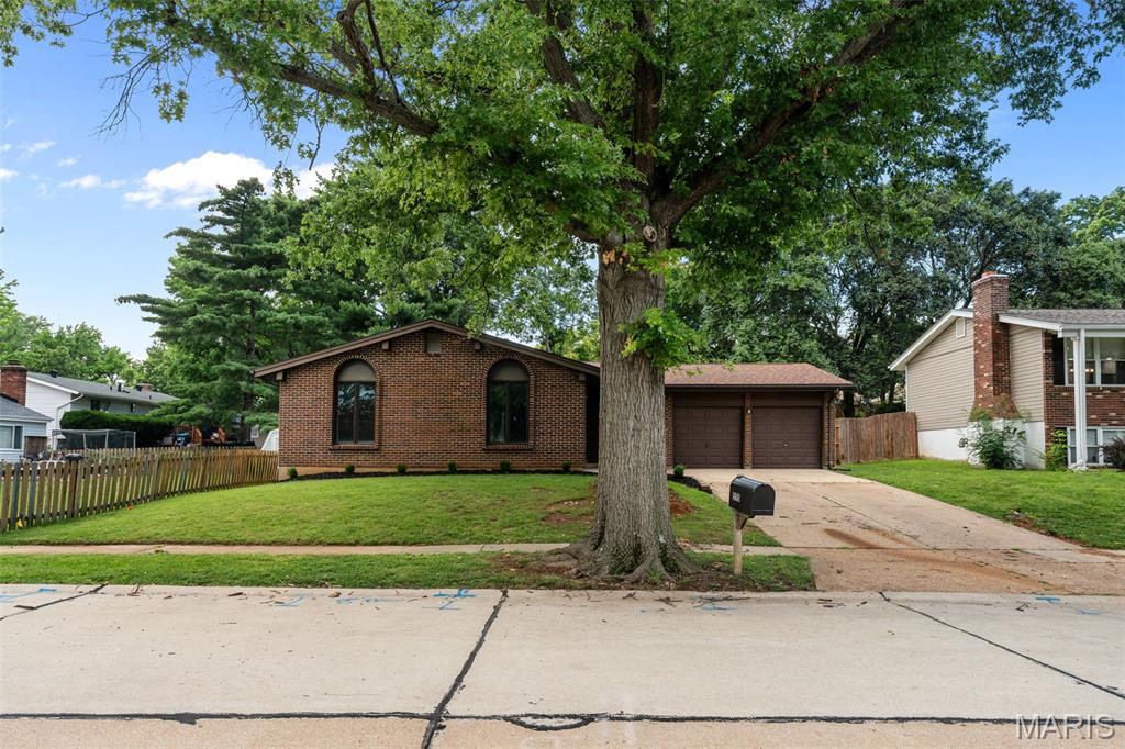 Welcome to this beautifully renovated ranch in Manchester! You'll be just steps from Hanna Woods Elementary and Schroeder Park! Located on a tree-lined street, this home has a brick front, new landscaping, and a large porch leading you inside. The foyer opens to the bright dining room with a stylish chandelier and new flooring that continues throughout the main living space. The kitchen is open to the dining and living rooms. It boasts quartz counters, stainless appliances, white 42" cabinets with crown molding, black fixtures and a timeless subway tile backsplash. Gather with friends and family in the cozy living room with a floor-to-ceiling brick-surround woodburning stove. The primary bedroom has dual closets and an en-suite bathroom with brushed gold fixtures and a step-in shower with gorgeous tile work. Three more bedrooms and another full bathroom with tile-surround tub, plus a convenient laundry room completes the space. You'll have plenty of storage in the unfinished basement. Enjoy summer on the patio overlooking the backyard shaded by large trees. In a great location, just moments from parks, schools, Hwy. 141, and all of the shopping and restaurants along Manchester and Big Bend roads, this home is one you won't want to miss!