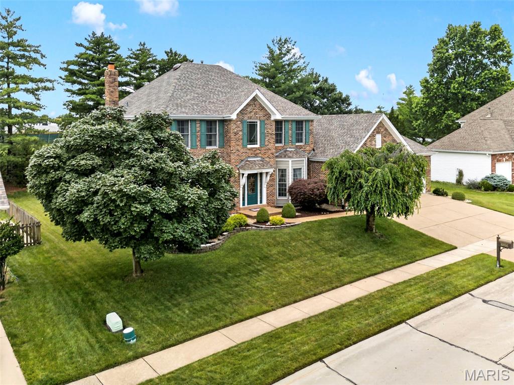 Welcome to this beautifully maintained two-story home nestled in one of Wildwood's most desirable neighborhoods. From the moment you step inside, you'll appreciate the timeless updates, abundant natural light, and flexible living spaces designed for today's lifestyle. The main level features rich wood flooring, elegant plantation shutters throughout, and separate living and dining rooms that offer versatility for entertaining or can easily serve as a private home office. The vaulted kitchen is the heart of the home, boasting granite countertops, ample cabinetry, and an open feel that flows seamlessly into the adjoining living spaces. Upstairs, you'll find four spacious bedrooms, including a luxurious primary suite highlighted by a stunningly updated bath featuring a heated floor, dual vanities, a separate soaking tub, and a walk-in shower—creating the perfect spa-like retreat. The partially finished lower level adds valuable living space while still offering abundant storage, a bathroom rough-in, and endless opportunities for future customization. Outside, enjoy relaxing or entertaining on the maintenance-free composite deck overlooking a level, tree-lined backyard with irrigation system. Location is everything, and this home delivers. Situated just a stone's throw from Lafayette High School, you'll enjoy the convenience of easy access to one of the area's most sought-after schools while still enjoying the privacy and tranquility of a tree-lined backyard setting. Additional updates include replacement of approximately 60% of the home's windows and 3-panel Anderson patio door, providing improved energy efficiency and peace of mind. New roof (January 2026) with Class 3 impact rated shingles. New water heater (April 2025). A smart thermostat controls the home’s heating and cooling system. Located in the award-winning Rockwood School District and minutes from Wildwood Town Center, parks, trails, shopping, and dining, this move-in-ready home offers the perfect blend of comfort, style, and convenience.