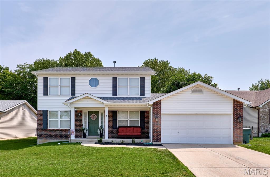 Welcome to this spacious and updated 2-story in a great Cottleville location! Brick accents and a covered front porch add curb appeal and lead you inside. The foyer opens to the dining room on the right and living room on the left, both featuring stylish lighting and luxury vinyl plank flooring that continues throughout the main level. The open layout of the main space is perfect for hosting gatherings or everyday family living, with the family room flowing seamlessly into the breakfast room and kitchen. You’ll love the cozy woodburning fireplace with brick surround, bay window, coffee bar area with a butcher-block counter, and the updated kitchen with open shelving, 42” cabinets w/crown molding, granite countertops, stainless steel appliances, and a timeless subway-tile backsplash. An updated half bath and convenient laundry room round out the main floor. Upstairs, the primary suite features a walk-in closet and bathroom with a dual-sink vanity and modern black fixtures. Three more bedrooms and another full bathroom complete the space. The finished basement adds a rec room with a kitchenette, bar area, and full bathroom. Enjoy summer in the backyard, with two patios and a fire pit, backing to woods. Conveniently located moments from Francis Howell Central schools, all of the restaurants and shops on Mid Rivers Mall and in charming Old Town Cottleville, with quick access to highways and extensive walking and bike paths along the Dardenne Greenway, this home is one you won’t want to miss!