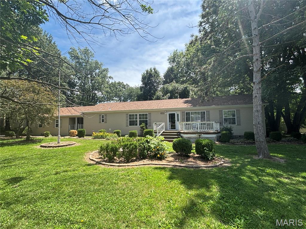 Looking for a move-in ready, well-maintained home near the lake? This spacious 1,700+ square foot manufactured home has been exceptionally cared for and offers the quality, space, and comfort that make it hard to believe it's a manufactured home. The desirable split-bedroom floor plan provides privacy, featuring a large primary suite with a full bath that includes a step-in shower with seating, a relaxing corner tub, and plenty of space to unwind. Two additional bedrooms and a full bath are located on the opposite end of the home.

Designed for both everyday living and entertaining, this home offers a cozy family room with a propane gas fireplace, a separate formal living room, and a beautifully appointed kitchen at the heart of the home. You'll love the newer appliances, abundant cabinet space, center island, and pantry for extra storage.

Situated on approximately 0.78 acres, this property offers room to enjoy the outdoors while being just minutes from the lake and all the recreation it has to offer. A large covered deck. The attached two-car garage offers convenience, while the additional detached garage provides extra storage space for boats, golf carts, lawn equipment, or hobbies.

If you've been searching for a spacious, move-in ready home close to the lake, this one is a must-see!