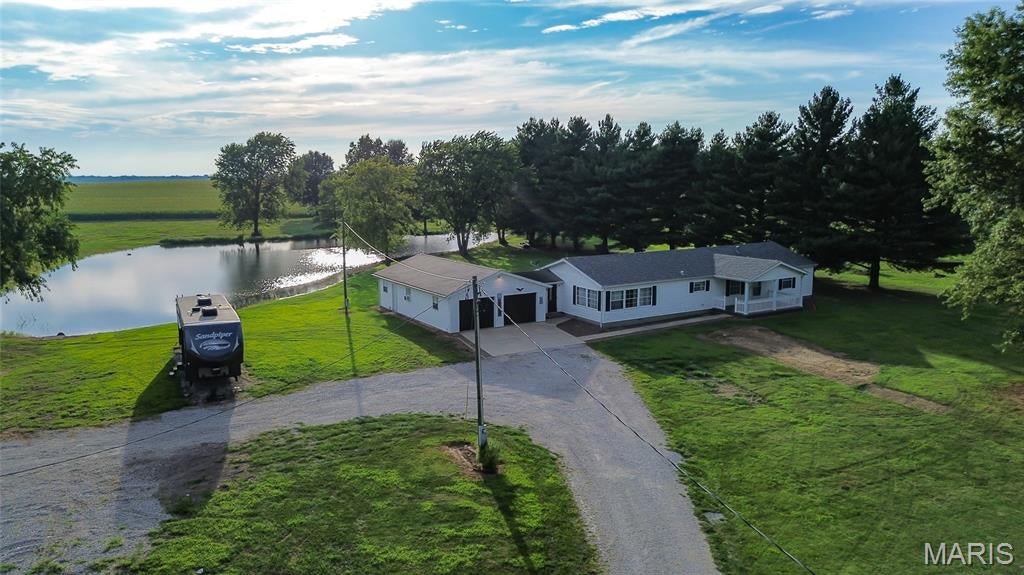 Experience the peace and privacy of country living on this beautiful 7-acre setting at 837 Pokey Rd. Surrounded by wide-open space and a serene stocked pond, this 3-bedroom, 2-bath home with a brand new roof offer being put on in Sept. 2026 the perfect blend of comfort, functionality, and room to enjoy the outdoors. Inside, cathedral ceilings create an open and inviting feel, while the spacious eat-in kitchen features an abundance of cabinetry, a breakfast bar, and plenty of room for gathering. Appliances are included. The primary suite offers two closets and a private bath. In the living room, an atrium door opens to the deck, where you can relax and take in peaceful views of the pond and surrounding countryside. Car enthusiasts, hobbyists, or anyone needing extra workspace will appreciate the impressive 40x24 attached 4-car garage, along with a 28x57 outbuilding equipped with heat and hot and cold water. With 7 beautiful acres, a stocked pond, generous garage, tons of outbuilding space, and a peaceful country atmosphere, this property offers the space and setting to truly enjoy life outside of town.