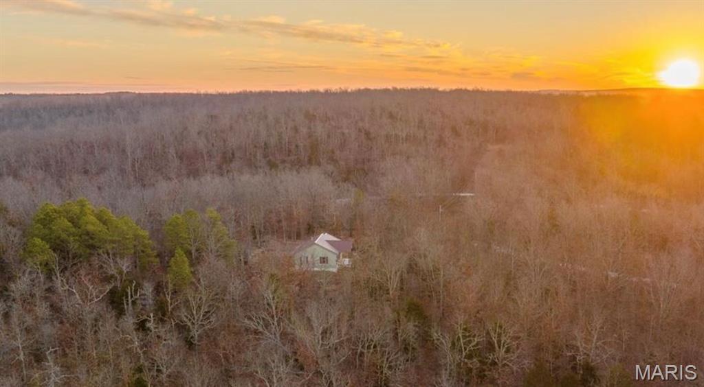 Tucked away on 35 acres, this property offers the privacy and quiet of country living with the convenience of being close to town. Located just 1.4 miles off Hwy 63 south of Edgar Springs, MO, it provides easy access while still feeling wonderfully secluded. A gated entrance adds an extra layer of security and privacy as you arrive.
Built in 2019, the home has a modern, like-new feel throughout. The attached two-car garage leads into an open-concept living space that combines the kitchen, dining, and living areas for comfortable everyday living. Two bedrooms are thoughtfully positioned on opposite sides of the home with a full bathroom in between. A covered front porch overlooks the surrounding trees perfect for relaxing and enjoying the peaceful setting.
Additional features include a laundry area in the garage, a newly built hobby shed with its own porch, and a newly drilled well. The home is equipped with full electric service, propane forced-air heat, and central air conditioning. A wet-weather creek meanders through the property, adding to the natural beauty and charm of the land. Outside, a small yard area with a fire pit creates an inviting space for gatherings with family and friends.
Whether you’re searching for a full-time residence or a cozy cabin retreat, this property fits the bill. Plus, you’re just 15 minutes from National Forest and State Conservation areas, offering endless opportunities for outdoor recreation.