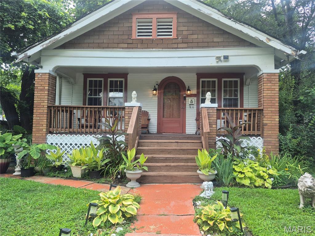 SWEET BUNGALOW ON CORNER LOT. FULLY FENCED YARD IS BEAUTIFULLY LANDSCAPED.  SMALL COURTYARD ON THE SIDE OF THE HOME HAS A CALMING EFFECT. WHILE-AWAY TIME ON THE FULL FRONT PORCH. ENTRY HAS ORIGINAL ARCHED STORM AND FRONT DOOR, WHICH LEADS TO LIVING ROOM AND DINING ROOM. ORIGINAL WOOD FLOORS IN LIVING ROOM, FORMAL DINING ROOM AND 2 BEDROOMS. DINING ROOM HAS AWESOME CRYSTAL CHANDELIER. MAIN FLOOR BATH IS UPDATED AND HAS CERAMIC TILE FLOOR. EAT-IN KITCHEN HAS NEW LVP FLOORING. SS GAS STOVE WITH SS HOOD AND SS FRIDGE WILL STAY. ENCLOSED PORCH/SUNROOM OFF THE KITCHEN. LOWER LEVEL HAS HUGE LAUNDRY AREA, SLEEPING ROOM AND FAMILY ROOM. HUGE WALK-IN CLOSET/STORAGE ROOM. HANDY HALF BATH IN LOWER LEVEL. BASEMENT HAS BEEN WATERPROOFED AND HAS SUMP PUMP.  OFF STREET PARKING IN BACK YARD. DETACHED GARAGE FOR STORAGE. HOME IS BEING SOLD AS-IS INCLUDING CITY OCCUPANCY INSPECTION. NEED 24 HOUR NOTICE FOR SHOWINGS. NO SIGN. ASK AGENT ABOUT PERSONAL PROPERTY INCLUSIONS AND EXCLUSIONS.