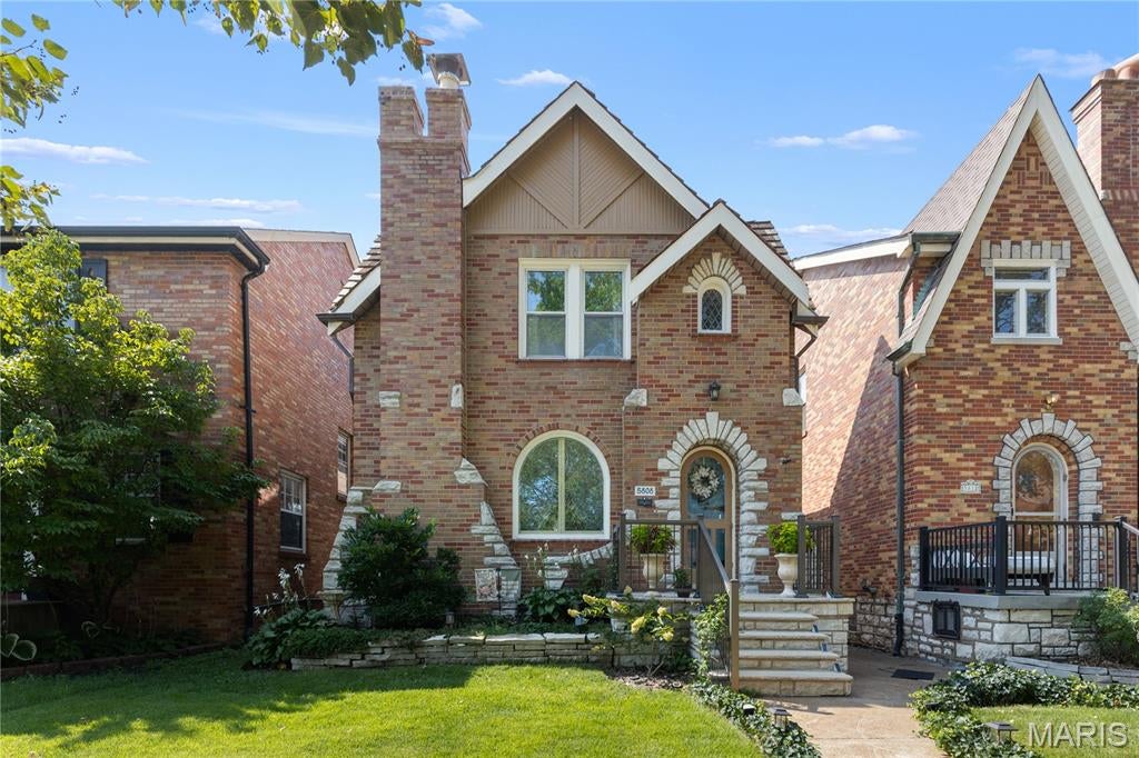 Pop In, Pour One, Take a Tour — Happy Hour Open House, 9/17! Built in 1932, this charming stone-and-brick Tudor is nestled on a tree-lined street in the heart of St. Louis Hills, just moments from beloved Francis Park and Ted Drewes. Timeless character shines throughout with cove ceilings, a beautiful stone fireplace, beveled dining room entry, and original hardwood floors. 
The kitchen blends classic style with modern convenience, featuring black granite countertops and new stainless steel appliances. Upstairs, two bedrooms and a fully remodeled second bath provide comfortable, private living space.
Thoughtful updates offer peace of mind, including relined sewer laterals, new sidewalk, updated front porch railings, refinished hardwood floors, chimney crown replacement with tuckpointing, custom wood storm door, and full exterior perimeter sealing, tuckpointing, and painting.
Outside, enjoy a functional mudroom, dreamy patio, freshly landscaped yard, and spacious 2-car garage. Full of character, thoughtfully updated, and ideally located, this is a rare opportunity to own a piece of St. Louis Hills history.
