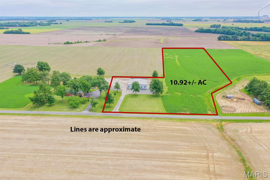 Price listed is Starting Bid Only. Bidding starts closing 07/16/2026 @ 6:30 p.m. Rare opportunity to own a versatile 5,625± square foot concrete block building situated on a surveyed 10.92± acre tract with access from Beckmann Road in Lenzburg. The office area includes four enclosed offices, a reception area, a large conference room located near a half bathroom, and a walk-in safe. The warehouse portion features a 20' x 14' bay door, a 14' x 14' bay door, poured concrete flooring, an additional half bathroom, and a loft with built-in shelving for added storage. The building previously served as an airplane hangar and could easily be utilized as one again. An additional 8.24± acres of tillable ground are currently leased with farming rights in place through 2026, providing immediate income potential. While the acreage is actively farmed, it has also functioned as a quarter-mile private airstrip and could potentially be reinstated with the proper approvals and registrations. The property is zoned A-Agriculture under St. Clair County zoning regulations. Certain commercial or other non-permitted uses may be possible through approval of a Special Use Permit from St. Clair County. With more than 10 acres of surveyed land, the property offers ample open ground and flexibility for a variety of permitted agricultural, aviation, recreational, or other approved uses. Conveniently located with easy access to surrounding communities and major thoroughfares, this unique property combines functional improvements, income-producing farmland, and potential for a wide range of future uses subject to applicable zoning approvals.  Property will sell under auction terms and be sold AS- IS, WHERE-IS. Seller, will not make any repairs as a result of any building, occupancy, or environmental inspections. Buyer will be required to sign an Auction Purchase & Sale Agreement if final bid is accepted by Sellers.