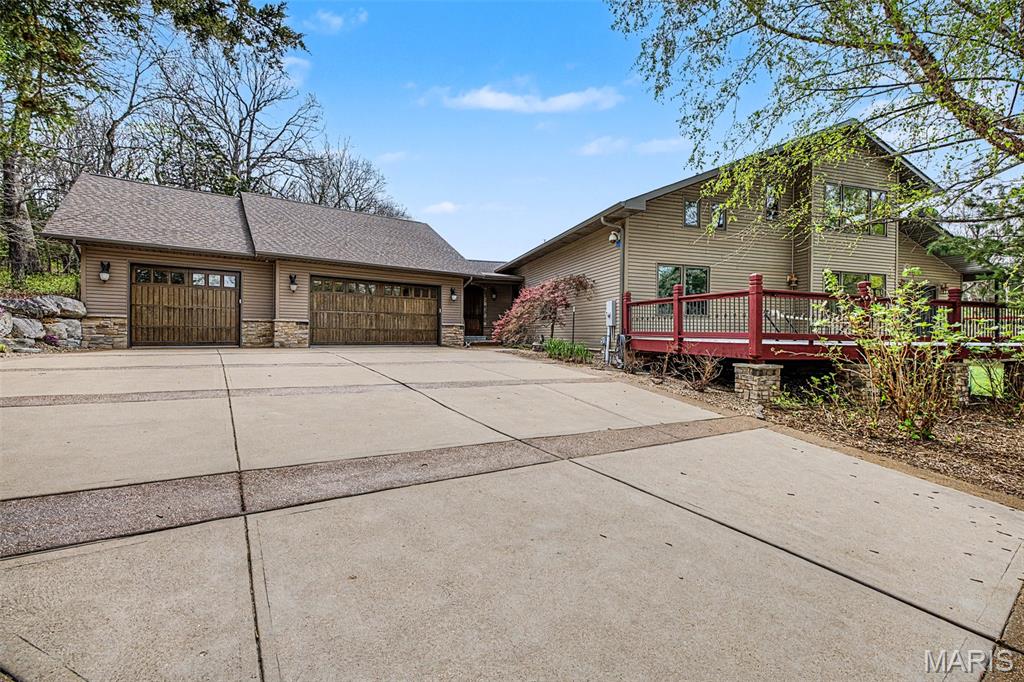 Looking for a private Oasis? Don't Miss out on this opportunity. This 4 bedroom, 4 full bath is nestled on 40+ acres. Feel yourself exhale as you enter along the wooded driveway that opens to lush fields. Roughly half of the property is wooded, plenty to explore hiking or on your UTV. The other half of the property is open fields where deer and turkey roam. This home offers plenty of space to spread out including a sunroom perfect for viewing wildlife. The large kitchen includes two dishwashers, two refrigerators and a large island perfect for baking and hosting guests. In the great room the wood burning fireplace will warm you through the winter. Deck doors open to an expansive deck that wraps two sides of the home, perfect for an afternoon nap or celebrations. Two bedrooms are on the main level. Upstairs both bedrooms are en-suite. The second floor also includes open space perfect for an office, workout room or large closet. Let it flex your needs. The finished lower level is perfect for entertaining including game day parties and features a kitchenette with a side by side refrigerator and dishwasher. There's plenty of storage throughout the home. Speaking of storage, the attached 3-car garage is oversized allowing for plenty of circulation around your vehicles and ample storage room in front. Oversized truck? No problem. The 50x70 shop has a concrete floor, 14'' service doors and includes 200 amp service with two 50 amp plugs and a 30 amp plug. There's plenty of space for your "toys" and gear. A wood burning stove in the office will take the chill out of those cold fall and winter days. 
So many features, don't miss out on this opportunity to own a piece of paradise. This property won't last long come  see it now.