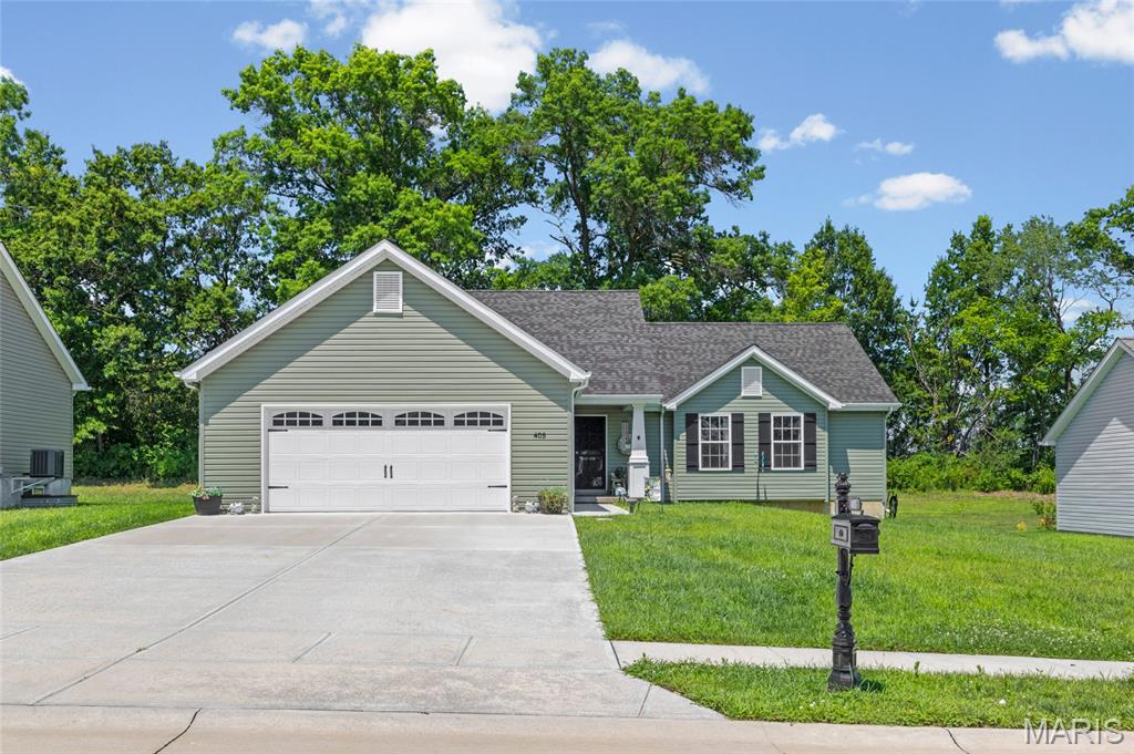 Welcome home to 405 Rail Ridge in Troy! This beautiful 4-bedroom, 3-bath ranch offers the perfect blend of comfort, space, and privacy. Step inside to an inviting open floor plan with soaring vaulted ceilings that create a bright and airy feel throughout the main living area. The spacious kitchen flows seamlessly into the dining and living spaces, making it ideal for entertaining or everyday living. The generous primary suite provides a relaxing retreat with plenty of room to unwind, while two additional bedrooms upstairs offer flexibility for family or guests. The partially finished basement adds valuable living space for a sleeping area or a home office. Outside, enjoy your morning coffee or evening gatherings on the covered patio overlooking a peaceful tree-lined backyard. Nestled in a quiet neighborhood while still being conveniently close to highways, don't miss your opportunity to own this one!