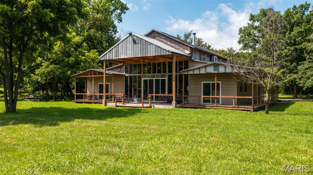 RUSTIC CHARM MEETS MODERN COMFORT! This 3-bed, 3-bath home offers 2,565 sq ft of warm, inviting living space with an open-concept layout, cathedral ceilings, and rich natural woodwork. Enjoy a spacious loft perfect for a family room, a cozy wood-burning stove in the dining area, and a wall of windows that brings in light—and views of surrounding wildlife. Features include a walk-in pantry, walk-in closet, and a stylish mix of concrete, tile, and carpet flooring. Set on 6.5 private acres, this property blends comfort, space, and scenic beauty. Even better, the adjoining land is also available for purchase, presenting a rare opportunity to expand your vision. Seize the chance to make this extraordinary, one-of-a-kind home yours. Opportunities like this are rare. Don't miss your chance to own it!