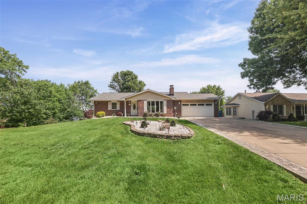 Welcome to lakefront living at its finest!  This full brick walkout ranch is perfectly positioned in one of the lake's popular coves, offering breathtaking water views and the ideal blend of privacy and convenience.  Designed for both everyday living and entertaining, this home features spacious living areas, 4 bedrooms, 3 full baths, a large deck, and a full walkout lower level with endless possibilities.  Step outside to your own slice of paradise, where you'll appreciate the peaceful cove setting tucked right off the main channel, easy water access from your private covered boat dock, and spectacular sunsets from your waterfront deck.  Wether you're hosting family and friends, or heading out for a day on the lake, this property delivers the lifestyle you've been dreaming of.  Don't miss this opportunity to own a full brick walkout ranch with prime cove location in beautiful Holiday Shores.  Buyer/Buyers Agent to verify all information.  Home sold AS IS.