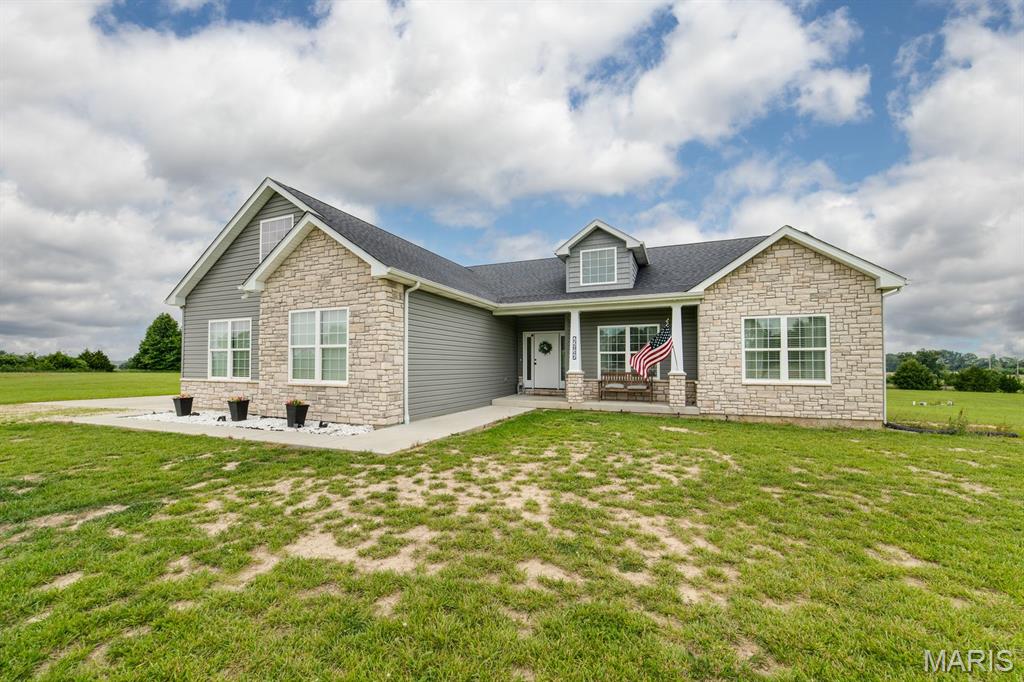 Peace and serenity await in this beautifully custom-built ranch home (2022), ideally positioned at the end of a cul-de-sac on 3 private acres in Warrenton just 3 miles off I-70. A unique opportunity exists to purchase an additional adjoining 3-acre lot*, creating a total of 6 + acres and offering ultimate privacy with future possibilities. 

This thoughtfully designed 3-bedroom, 3-bath home offers an open-concept layout filled with natural light and spacious living areas. The inviting foyer leads into a large living room featuring a gas fireplace, flowing seamlessly into the kitchen and dining area. The kitchen is built for both everyday living and entertaining, showcasing a large center island with calcutta quartz countertops, a huge walk-in pantry, and convenient access to the laundry room with sink. Just off the dining area is a dedicated home office that can easily be converted into a fourth bedroom, offering flexible living options. 

The main level features 9-foot ceilings and luxury vinyl flooring throughout, enhancing the home’s bright and airy feel. The primary suite includes a soaking tub, separate shower, and dual vanities. The partially finished lower level provides additional living space with 8.5-foot ceilings, luxury vinyl flooring, and a full bath—ideal for a recreation room, media space, or additional living quarters. 

Outdoor living is highlighted by a covered patio overlooking peaceful wooded surroundings and neighboring farmland, offering exceptional privacy with no rear neighbors. A three-car garage provides ample parking and storage additional features include stone and vinyl exterior, well and septic system, and a propane gas fireplace, within a small community. 

*Additional adjoining 3-acre lot available for $70,000. The lot may be retained for added privacy or future use. Per HOA guidelines, the lot is designated for residential construction; outbuildings are not permitted as a standalone use.  

A rare opportunity to own a newer custom home with acreage, privacy, and future potential—schedule your showing today!