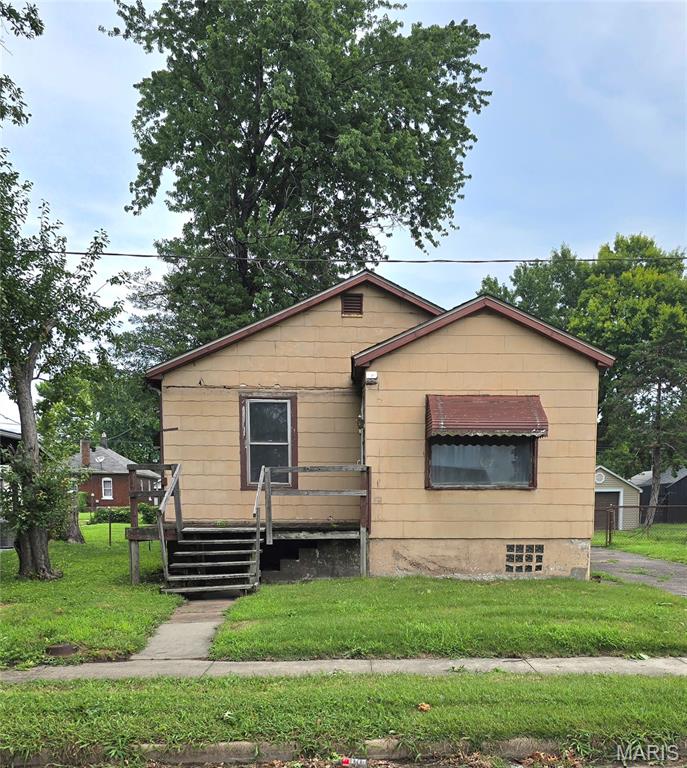 This property is the perfect sized two-bedroom, one bath someone looking to renovate to sell or hold as a rental property.  In the past, someone has changed the layout to support a more open concept with the second bedroom and can easily be converted back.  This kitchen has mid-century cabinets and a nice breakfast nook.  The property has a detached garage and an intact chain link fenced, level back yard.  Located on a quiet street with a short distance to local amenities.  Property is being sold 'as, is'.  Seller will not be making any repairs or giving any repair credits.  Seller will not be ordering a home sale inspection.  Call your favorite agent today for a private tour.