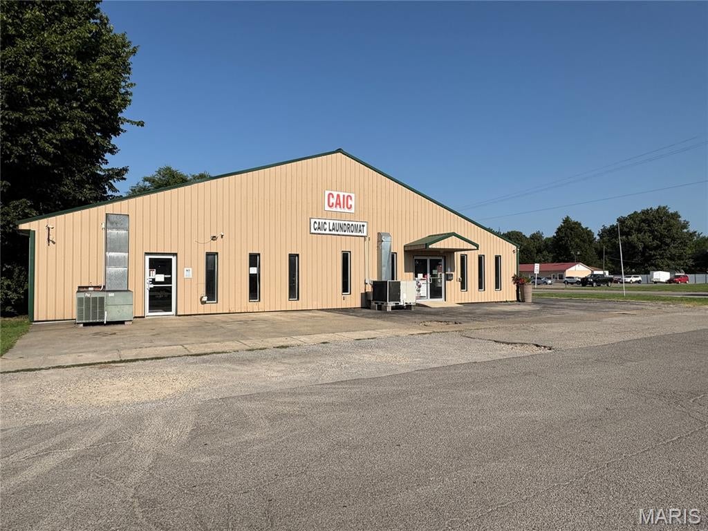 Excellent commercial opportunity offering flexibility, visibility, and an established
business all in one! Situated on a level corner lot with high visibility along US Business
60 in Dexter, this all-metal building offers approximately 6,408 square feet of space. The
original 2,208-square-foot portion was constructed in 1990, with an additional 4,200
square feet added in 2010. A dividing wall separates the two sections, with double-door
access allowing the building to function as one large commercial space or be closed off
to accommodate two separate businesses. Each side also features its own storage
room at the rear for added functionality. The smaller portion is currently home to an
operating laundromat, and the business and equipment are included with the sale,
providing an opportunity for a new owner to step into an existing operation while utilizing
or leasing the additional space. An asphalt parking lot provides parking for up to 16
vehicles. With its adaptable layout, prominent corner location, ample parking, and
income-producing potential, this property offers a variety of possibilities for an owner-
user or investor.