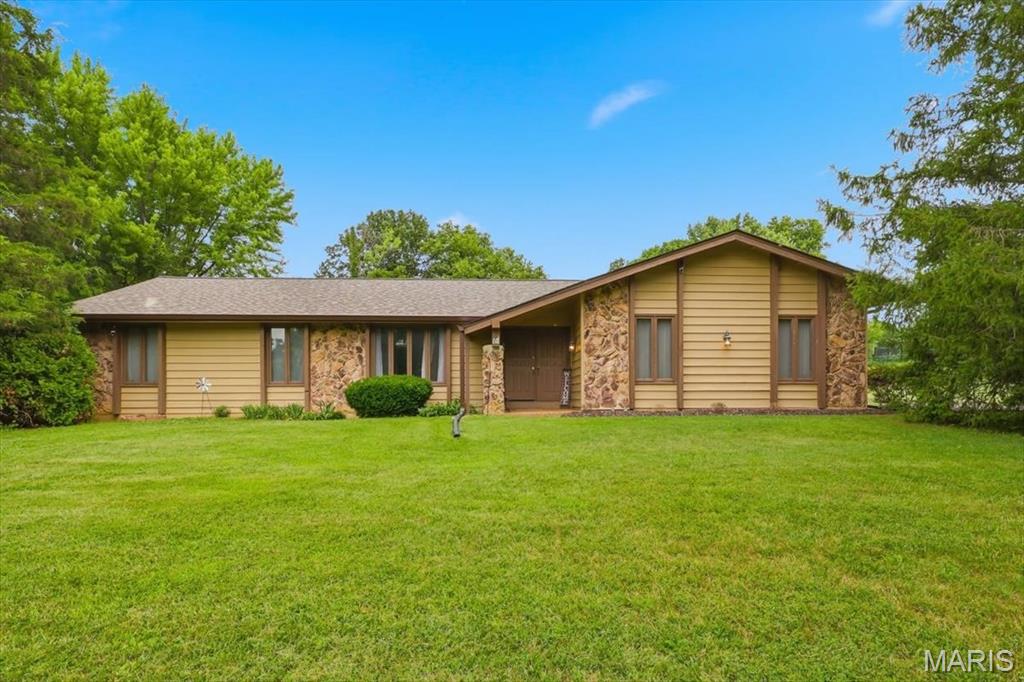 Welcome home to this 3-bedroom, 2.5-bath home situated on 1.3 acres in a quiet cul-de-sac. This home is ready for its new owner to add their personal touches and make it their own! As you arrive, you'll notice the large driveway, spacious front yard, and inviting covered front porch. Step inside to a spacious family room featuring vaulted ceilings, a stunning wood-burning stone fireplace, and neutral paint colors that provide the perfect backdrop for any style.
The kitchen offers plenty of counter space and cabinetry, along with an eat-in kitchen and separate breakfast room. Step outside to your large, private backyard where you can enjoy barbecues, sip your morning coffee, or simply relax while watching the local wildlife.
The separate dining room showcases beautiful architectural openings, adding charm and character to the home. Down the hallway, you'll find the primary suite complete with its own closet and private bathroom, along with two additional bedrooms and a full hall bath.
The unfinished lower level includes a finished half bath and offers endless potential to create additional living space, a recreation room, home office, or gym.
Don't miss this opportunity to own a home in a highly desirable neighborhood while adding your own style and updates to make it truly yours!
