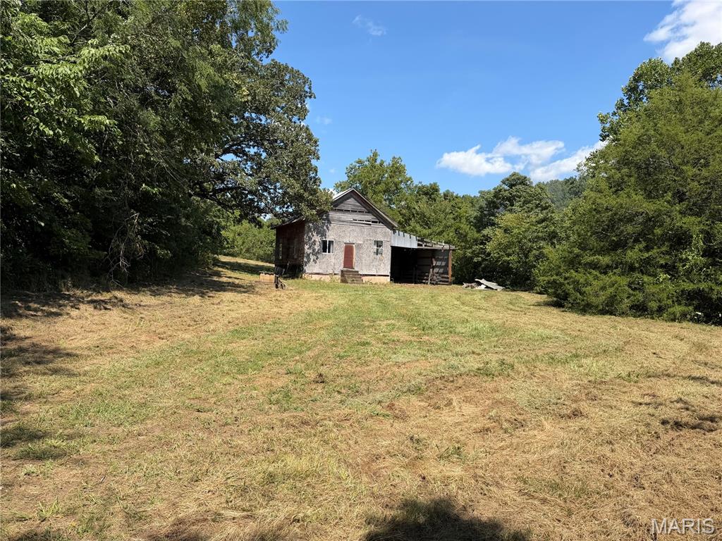 Opportunities like this don’t come around often. This 49.52-acre tract in Wayne County, Missouri offers a rare combination of history, privacy, and outdoor recreation. A historic one-room schoolhouse serves as a unique centerpiece, while the barn, pond, wet-weather creek, and established trail system add to the property’s charm and usability. Multiple beautiful building sites make it easy to envision your dream home or weekend getaway. Electricity is available, and a hand-dug well is already on the property. Best of all, the back of the property borders public land, giving you direct access to additional acreage for hunting, hiking, and exploring. Whether you’re searching for a homesite, recreational property, or an investment in the Ozarks, this one is ready to be enjoyed.

Agent Owned