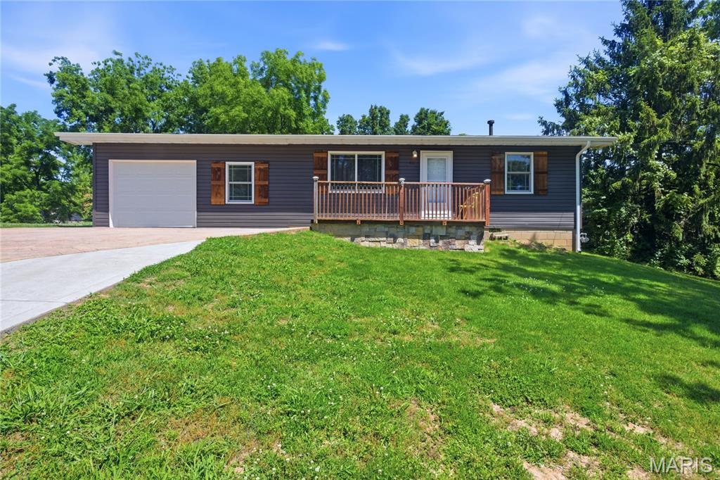Welcome to 451 Crane Street in Herculaneum, Missouri—a beautifully updated, move-in-ready ranch offering comfortable one-level living, an open floor plan, extensive recent improvements, and inviting indoor and outdoor spaces. This three-bedroom, one-bath home combines practical everyday living with the character and convenience buyers are searching for.

Step inside to a bright, open interior where the living room, dining area, and kitchen connect naturally, creating a comfortable setting for daily living and entertaining. Large windows bring natural light into the living space, while the open layout allows flexibility for arranging furniture, dining, and gathering areas. The kitchen offers generous cabinet and workspace, along with convenient access to the adjoining laundry and utility room. Having the laundry located just off the kitchen keeps household tasks accessible without sacrificing valuable living space.

Bedrooms are conveniently located on the main level and offer comfortable space for sleeping, working, hobbies, or additional storage. The updated full bathroom includes a step-in shower for convenient access. With all primary living areas located on one floor, the home provides an efficient layout without interior stairs.

Numerous major improvements have been completed since the property’s previous sale in 2023, helping reduce the need for immediate exterior and mechanical projects. Updates include a new roof, new windows, new siding, and a new HVAC system. These substantial improvements add to the home’s appearance, comfort, energy efficiency, and long-term functionality.

Outside, the stamped-concrete front patio and sidewalks create an attractive approach to the home and provide a welcoming place for outdoor seating or seasonal decorating. The updated stamped-concrete driveway leads to the attached one-car garage, offering convenient off-street parking and additional space for tools, lawn equipment, or household storage.

The large, level backyard provides plenty of usable outdoor space for recreation, gardening, pets, grilling, or creating your own outdoor entertaining area. A sizable detached storage shed adds valuable room for lawn equipment, bicycles, recreational items, tools, and seasonal belongings. The flat backyard easy to enjoy and maintain, while the existing patio areas offer a strong foundation for expanding your outdoor living space.

The location adds even more convenience. The property is near Herculaneum High School, local parks and recreation, shopping, restaurants, and everyday services. Herculaneum City Park is located nearby, and the city’s park system provides opportunities for outdoor activity, recreation, and connection with nature. Convenient access to major highways makes travel throughout Jefferson County and the greater St. Louis area straightforward.

Whether you are looking for your first home, a comfortable one-level residence, a low-maintenance property, or a home with substantial recent updates already completed, 451 Crane Street deserves a closer look. With its open floor plan, updated systems and exterior, attached garage, stamped-concrete improvements, large storage shed, and spacious level backyard, this home offers an appealing combination of comfort, functionality, and convenience.