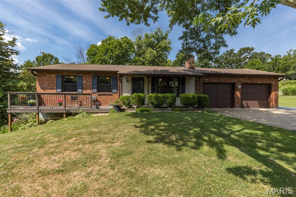 Welcome home to this meticulously maintained, one-owner ranch nestled in the highly sought-after Festus School District. Sitting on almost one beautiful acre, this property offers the perfect blend of comfort, pride of ownership, and peaceful country living—while still being close to town conveniences. From the moment you arrive, the gorgeous landscaping and inviting covered front porch to create a warm and welcoming first impression. Inside, you will immediately feel how lovingly this home has been cared for over the years. The spacious living room features a cozy wood-burning fireplace, creating the perfect gathering place for family, friends, and quiet evenings at home. The eat-in kitchen offers comfortable everyday living, and all appliances currently displayed in the home are included, making this an easy move-in opportunity. The primary bedroom includes its own private bath, while two additional bedrooms and a full hall bath complete the main level. Enjoy every season from the 12x16 three-seasons room, relax on the covered porch, or unwind on the 8x12 deck overlooking the peaceful front yard. The lower level is ideal for entertaining, offering a large family room, wet bar, full bath, and walk-out access—perfect for holidays, game nights, guests, or additional living space. A three-car garage provides plenty of room for vehicles, storage, hobbies, or workspace, and the 12x16 detached lofted outbuilding adds even more flexibility. Additional highlights include a 2-year-old roof, septic and well—meaning no sewer or water bill—and a beautiful setting that is hard to find. Homes like this, with one owner, almost an acre, a 3-car garage, finished walk-out lower level, and Festus Schools, do not come along often. This is more than a house—it is a place that has been loved, maintained, and is ready for its next chapter. Rare find and truly a must-see!