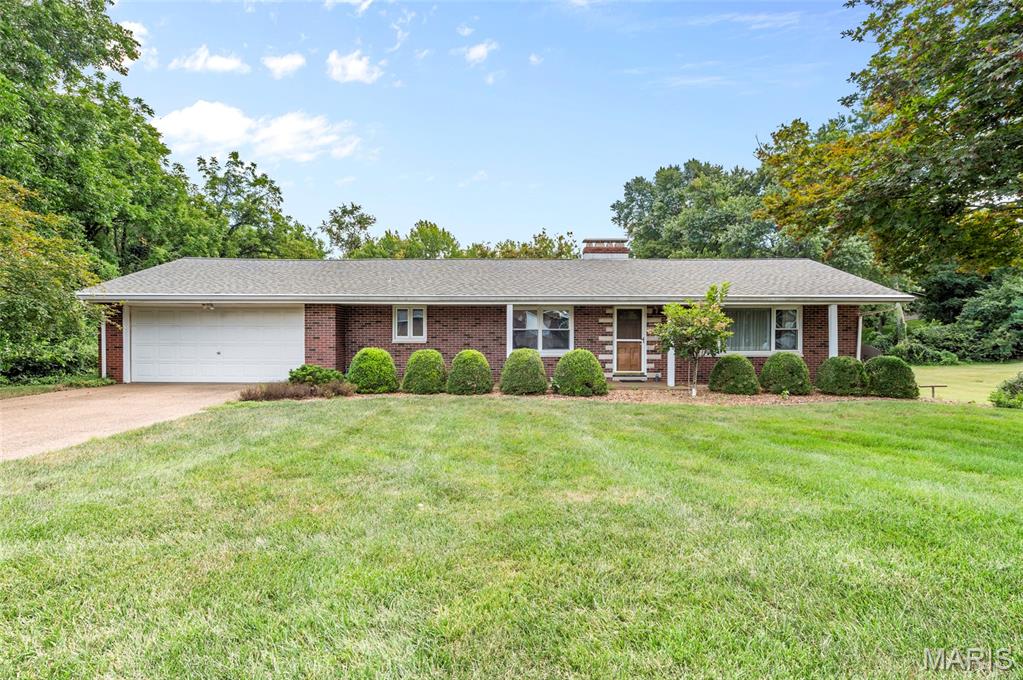Welcome to this charming all-brick ranch nestled on a spacious 0.76-acre lot.  The covered front porch welcomes you into the inviting living room, where a gas fireplace creates a warm and comfortable gathering space. The kitchen and dining area are thoughtfully combined for easy everyday living and entertaining. Three bedrooms and a full bath complete the main level. The walk-out lower level expands the living space with a large recreation room, bar area, pool table, 2nd fireplace and full bath, creating a versatile area for entertaining, relaxing or hobbies. Step outside from the lower level and enjoy the generous yard and peaceful wooded backdrop. With its all-brick exterior, convenient ranch-style layout, partially finished walk-out lower level and expansive lot, this property offers plenty of space to make it your own. Home is being sold AS-IS. Some photos have been virtually staged.