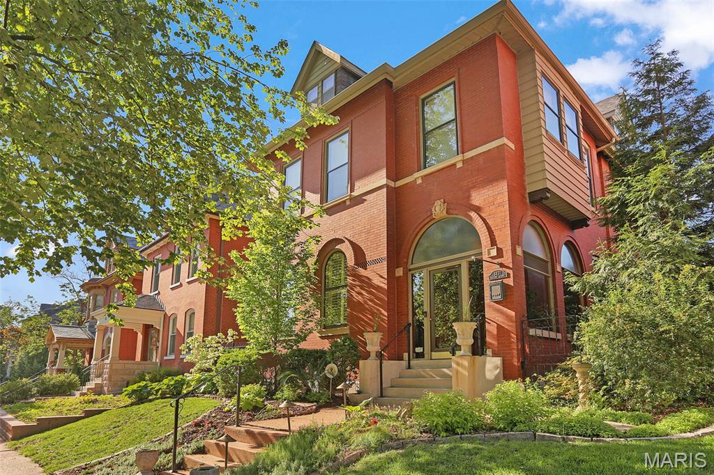 Get ready to unlock the doors to a brighter future in this stunning 1899 Gilded Age Tower Grove East gem!  Let the curb appeal usher you up into your glass enclosed porch where you can grab a seat and watch all the comings and goings of City living. Enter through the historic front door (gosh to think it is 127 years old) into a spacious grand foyer complete with stain glass windows (5), a glass chandelier and a gorgeous fireplace (1 of 4 in the house). Through an archway of scrolled fretwork you will find the living room complete with high ceilings, plantation shutters and a center gas fireplace. A great place to entertain all your friends in style. Through double doors you will find the next location of your soon-to-be legendary dinner parties, that even the Dowager Countess would approve of. The historic details abound in here with French doors leading down onto the outdoor verandas, intricate fireplace detail, a bayed wall AND striped original hardwoods. Through another set of double doors (or go the back way) you will enter your Chef's kitchen where you can let your inner Julia Child emerge. Quartz counters, tall white cabinets topped with crowns, deluxe SS appliances, original built-in hutch and the show stopper center island covered in stunning walnut. A convenient half bath with timeless subway tile walls is adjacent to the kitchen. Also adjacent is perhaps the place you will spend a lot of your time, the den complete with a newer mini-split, newer windows, cork flooring and exposed brick. The entrance hall contains a grand staircase that ascends you up to the 2nd floor, complete with a radius stain glass window and a glass chandelier (or take the back stairs). The primary suite is located at the front of the home and includes more hardwoods, crown molding, double closets, a private dressing room and an attached bathroom complete with a jetted tub. Bedroom #2 has an original fireplace and is just the right size. Bedroom #3 has a bayed wall of windows and a private Juliet balcony overlooking the backyard. The center guest bathroom has been overhauled and includes double sinks and an incredible walk-in shower. A dedicated laundry ROOM rounds out the 2nd floor. The 3rd floor finds bedroom #4 with another private Juliet balcony as well as a large walk-in closet and bedroom #5 is simply adorable with 3 spacious closets! A guest bathroom completes this floor. The partially finished basement includes a flex space that could be used as a rec room, playroom OR an additional kitchen space for holiday and party baking - complete with an oven and a portable dishwasher. A convenient water closet is handy and nearby. Don't fret, plenty of storage remains in the basement as you will need a place to store all the cool things you will use to decorate for the holidays here. The backyard is an entertainer's delight complete with patio spaces, luscious landscaping and a private side courtyard, perfect for morning coffee or evening wine. A newer over-sized 3 car garage completes the backyard. With being only located 1 block east of Tower Grove Park you will find yourself taking part in all the fun activities the Park offers as well as strolling along all the shops and restaurants on South Grand. This once in a lifetime historic home with nearly 5,000 sq ft of finished living space is ready for you to call her home. All this is missing is YOU!!!