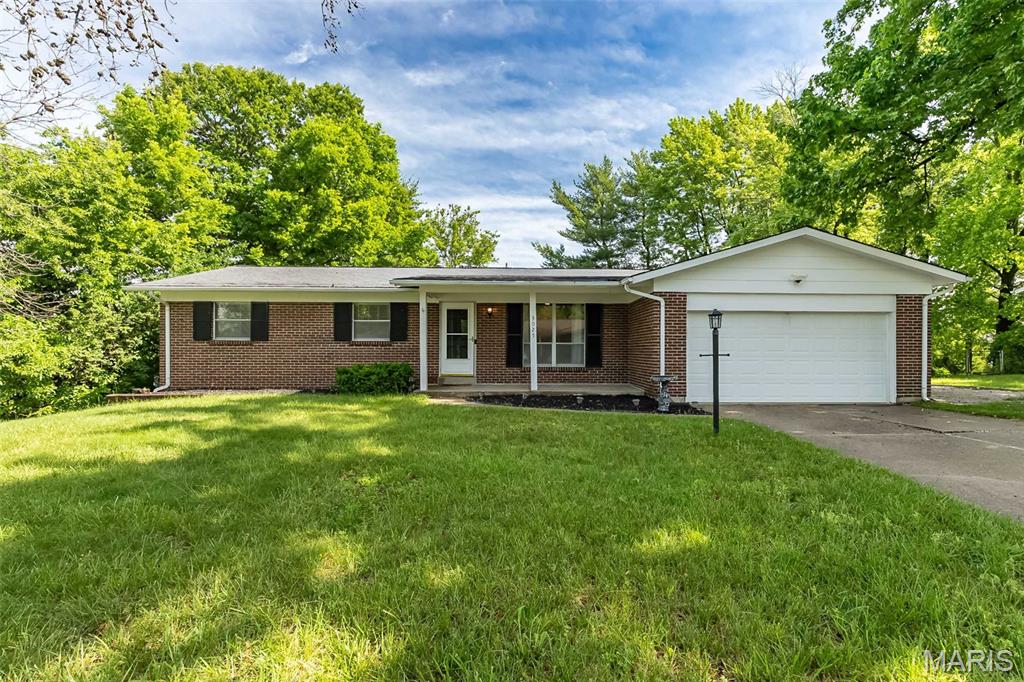 Welcome home to this charming updated 3 bedroom 2 bathroom ranch in the heart of St Peters. From the moment you arrive you'll appreciate the charming curb appeal, mature trees, and spacious 2 car garage. The home is inviting with hardwood floors and a striking accent wall in the living room. The kitchen is a showstopper, thoughtfully redesigned with custom cabinetry, butcher block counter tops, sleek fixtures, subway tile backsplash - truly an open and functional layout that is both stunning and practical. Walkout access from the kitchen to a covered patio and a level backyard. Downstairs, the basement includes a hidden "secret room" that would make the ultimate media room, private bar, or the ultimate man-cave. With modern updates, unique character, and versatile spaces, this home is move-in ready. Conveniently located near shopping, dining, parks, and major highways, this St Peters gem is ready to go!