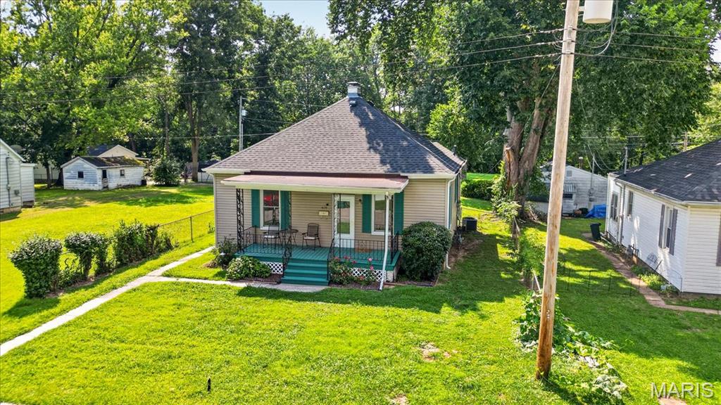 Location, character, and updates all come together in this charming 2-bedroom home right in the heart of O’Fallon! Step inside to find beautiful wood floors, wide wood trim, high ceilings, and plenty of the original character that makes this home stand out. The comfortable living room flows into an eat-in kitchen, with two bedrooms and a full bath completing the main living space. Enjoy your morning coffee or unwind at the end of the day on the covered front porch. Laundry is in the basement, but could potentially be moved to a closet on the main level with a stackable set. Out back, you’ll find a fenced yard with a storage shed plus alley access, offering potential for a future detached garage. Several of the big-ticket items have already been addressed, including a new roof and some new siding, along with newer HVAC, water heater, plumbing, and electrical. Conveniently located close to downtown O’Fallon with shopping, dining, schools, parks, and everyday amenities nearby. A great opportunity for someone looking for an affordable home with charm, updates, and a convenient in-town location! Professional photos coming 8-15.