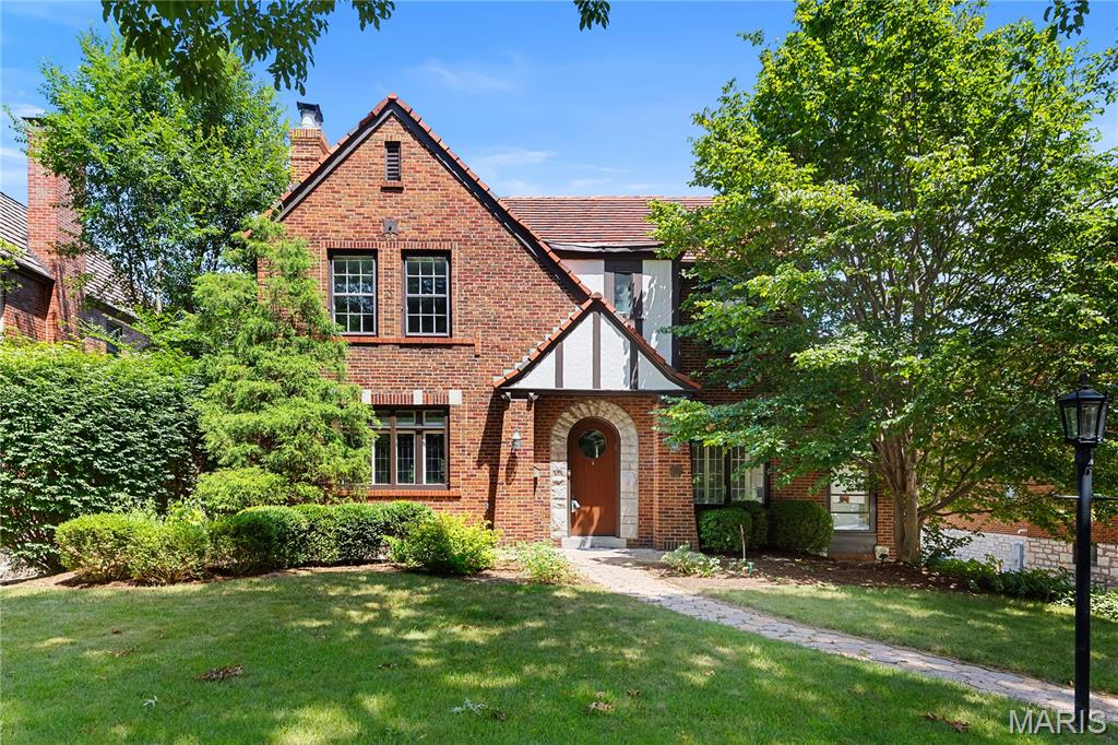 This elegant 2-story home exudes timeless majesty and refinement, offering an ideal backdrop for beautiful living. A gracious entryway—featuring arched doorways and a striking staircase—sets a welcoming tone upon arrival. The expansive living room is filled with natural light from abundant windows, creating a warm and inviting atmosphere. Arched doorways lead seamlessly into the equally handsome dining room, fostering a sense of architectural cohesion and enhancing the home's appeal for both everyday living and entertaining. Glass-inlaid doors open to a comfortable family room, perfect for relaxed gatherings and informal entertaining. From here, step out onto a spectacular deck that overlooks a magical backyard setting—an ideal space for outdoor leisure. A stylish main-level den offers the perfect opportunity for a home office or study. The kitchen, complete with a breakfast area and a conveniently located powder room, completes the main floor. Upstairs, you'll find four generously sized bedrooms, including a gracious primary suite with its en-suite bath. Bedrooms 2, 3, and 4 offer ample space and flexibility, while bedroom 4 opens to a delightful bonus room with built-in cabinetry—a versatile space ready to become a playroom or studio. A second full bath completes the upper level. Two garages and abundant storage space round out this truly special home.