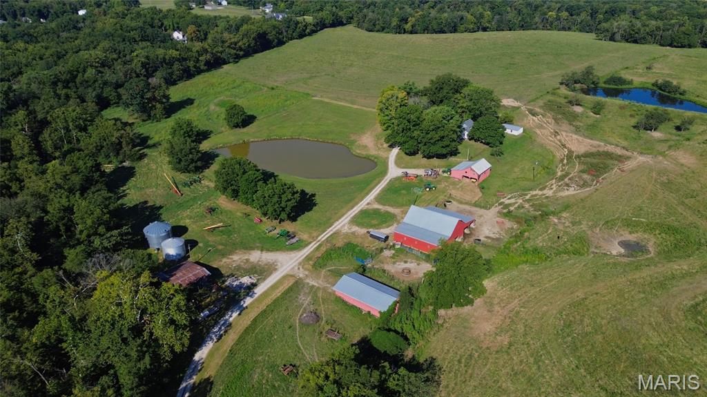 Boundless Possibilities make this Incredible 1880s Brick Farmhouse on 125 Acres ml, just minutes from Downtown Washington MO, a Once-In-A-Lifetime Oportunity. Whether you are looking for a turn-key working farm, your dream mini-farm, a sprawling country estate, agricultural investment, or future development site, this property will Check ALL the Boxes! With roughly 125 acres of continguous fenced pasture, you can bring your animals and start operating today with a small barn with lean-to, large barn with multiple stall sections, machine shed, old corn crib, and Pond. No Farm Animals in your future? Then schedule a tour today and start envisioning your dream country estate, perfect mini-farm, or convenient recreational property within 1 hour of Downtown St Louis. The original Farmhouse from 1889 boasts over 3,000sqft of living space above grade, excluding the 2nd floor potential bonus room or 4th bedroom. The front porch, overlooking the barns, pond & entrance, welcomes you into the home. The foyer connects the primary bedroom, living room, sunroom, & stairs to 2nd floor. Primary Bedroom features great natural light along with tall windows and closet. The spacious living room offers tall ceilings, views of the farm, and leads to Dining Room. The Dining Room connects living room to kitchen and the hallway to full bath and sunroom. Off the Dining, you can access the large kitchen with modern cabinets, appliances, and access to sunroom and laundry. The Laundry Room includes a propane heater, plenty of space, and door to main yard. The sunroom leads to driveway, garage, pond, and stairs to bonus room. The stairs have ornate woodworking as it curves around the landing to the 2 very large spare bedrooms with closets & tall windows overlooking the farm. In addition to the obvious agricultural and residential uses of the property as it sits, a future of commercial, industrial, or community development could be some potential use cases with its convenience to the industrial park, highways, and the City of Washington. With SO MANY possible uses, this property will attract interst from far and wide. Additional Bottom Ground Acreage on St Johns Island Rd Available, see MLS# 25066873 (112 m/l acres) & 25066868 (67 m/l acres) for more details. Showings Start October 15th, Schedule Your Tour Now. Don't Hesitate on this One-Of-a-Kind Farm!