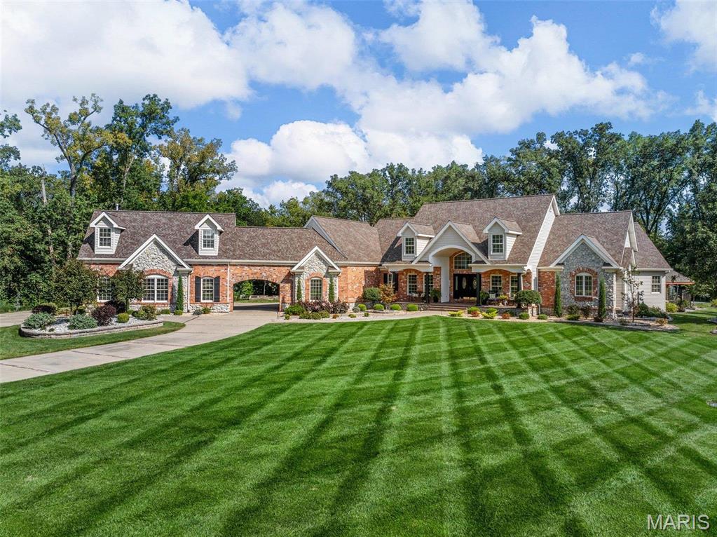 Set on over three acres of pristine land, this exceptional custom-built estate offers more than 6,400 square feet of refined living space, thoughtfully designed to combine elegance, comfort, and functionality. Featuring four expansive bedrooms and an impressive collection of upscale amenities, every detail reflects superior craftsmanship and timeless design.

The heart of the home is a state-of-the-art gourmet kitchen, appointed with premium appliances, custom cabinetry, and generous gathering areas ideal for both everyday living and grand entertaining. A newly designed custom office provides a sophisticated and private work environment, while meticulously crafted closets throughout the residence showcase attention to detail and organization.

Upstairs, a private stadium-style home theater creates a true cinematic experience. The lower level expands the home’s versatility with additional living space perfect for relaxation, recreation, or hosting guests.

Outdoors, the property transforms into a resort-style retreat. A stunning custom pool with elegant fountain features anchors the space, complemented by a fully equipped outdoor kitchen and a spacious covered living area designed for seamless indoor-outdoor entertaining.
Completing the estate is a generous five-car garage and a dedicated hobby room, offering flexibility for collectors, enthusiasts, or creative pursuits.

Blending timeless sophistication with modern convenience, this extraordinary residence delivers an unparalleled lifestyle experience in a private and serene setting.
