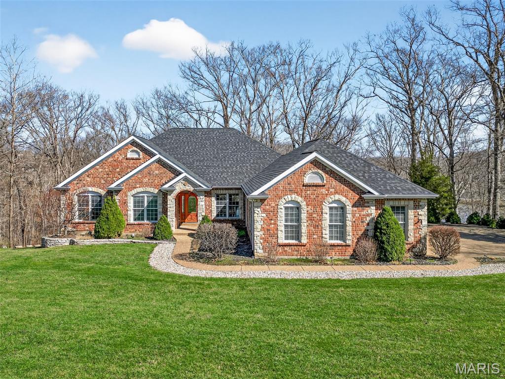 Welcome to desirable Forest Lake Estates and your opportunity to own a beautiful custom built atrium ranch on a spectacular 3.42 acre wooded lot which includes a shared lake. Situated on a quiet cul-de-sac and graced with stunning curb appeal, this home has been meticulously maintained and has some amazing features including: elegant MUST SEE hardwood floors, custom millwork & trim, vaulted-coffered & tray ceilings, open concept kitchen-breakfast & hearth area, 2 gas fireplaces, screened-in deck with a scenic tree line & lake views, oversized 31 x 27  finished & insulated 3 garage, and so much more. Enjoy over 4200+ sq ft of living space where each room offers amble size and is encompassed by excellent natural light from all of the windows. If this home wasn't enough, spoil yourself with a shared lake and enjoy fishing or playing in the water on those scorching hot Missouri days. Conveniently located minutes away from parks, wineries, dining, shopping, and in an excellent sought after Francis Howell school district. Thank you for your interest!