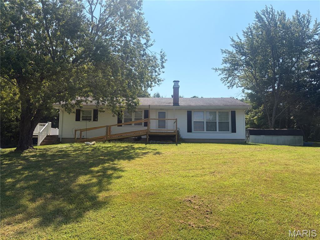 This spacious 3-bedroom 1.5-bath ranch offers approximately 2,600 sq ft and plenty of potential to make it your own. The home features a traditional layout with a large unfinished basement and a 2-car garage. Outside you’ll find a beautiful open field along with wooded areas and gentle slopes. This large shed would be perfect for all your hobby farming needs. The property also offers a metal building for additional storage or workspace. Enjoy the privacy and space of country living while having plenty of room for recreation animals gardening or simply enjoying the outdoors. If you’re looking for acreage and a home you can update to fit your vision this property offers a great opportunity to create something special.