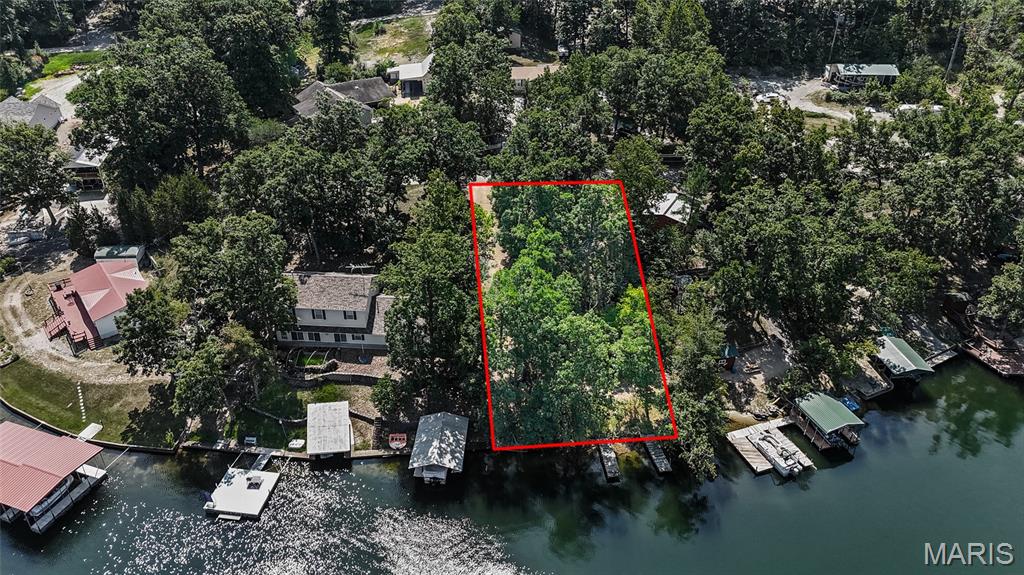 THIS IS ONE YOULL HAVE TO SEE TO APPRECIATE! 
Build, camp, relax, and enjoy lake life at Goose Creek Lake! This lakefront lot is tucked away in a quiet cove on a dead-end road, giving you a peaceful setting with plenty of possibilities. The property has already been leveled into three separate tiers, giving you a great head start on creating the perfect lake setup. Two cute little docks give you easy access to the water and a great place to fish, relax, or just enjoy the view. Electric is available next door, making a future hookup fairly simple.

Whether you're looking for a spot to park the camper for weekend getaways, build a cozy lake cabin, or create your own custom lake home, this property gives you plenty of options!

And Goose Creek is so much more than just a place to camp! The community is a mix of full-time residents, weekend lake homes, cabins, and recreational properties, making it a great place to enjoy however it fits your lifestyle. The approximately 400-acre main lake offers plenty of room for boating, swimming, fishing, and all kinds of lake fun. The community also offers a swimming pool, two playgrounds, parks, and family-friendly events throughout the year.

Whether you're looking for a peaceful weekend escape or somewhere to make memories for years to come, bring your plans and start enjoying everything Goose Creek Lake has to offer!