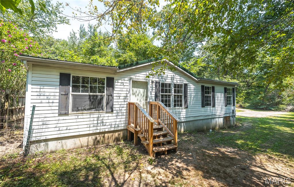 Welcome home to this NEWLY RENOVATED 3-bedroom, 2-bath manufactured home situated on approximately 0.35 acres in a peaceful setting in Bourbon. With 1,080 square feet of living space, this single-level home features an open floor plan with cathedral ceilings that create a bright and inviting atmosphere.

The spacious living area flows into the kitchen and dining space, making it ideal for everyday living and entertaining. The kitchen comes complete with an electric range, range hood, dishwasher, and refrigerator. The split-bedroom layout offers privacy, while the primary suite includes its own full bathroom.

Step outside to enjoy the large deck—perfect for grilling, relaxing, or entertaining family and friends. The level lot provides room for outdoor activities, gardening, or additional parking, including space for an RV or recreational vehicles.

Conveniently located within the Bourbon city limits, this property offers public water and sewer, central heating and air, and easy access to schools, shopping, and Interstate 44.

Whether you're looking for your first home, downsizing, or adding to your investment portfolio, this move-in-ready property is one you won't want to miss. Schedule your private showing today!