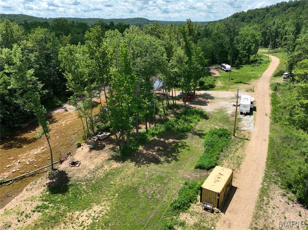 Tucked away along the peaceful banks of Twelve Mile Creek. This rare .75 m/l acre getaway has appx 220 feet of creek frontage and is only 10 miles south of Fredericktown. Electric is already on site and in place, making it ready for weekend escapes or extended stays. You'll enjoy easy access to fishing, swimming, campfires and quiet evenings by the water. Additionally, Mark Twain National Forest is nearby with over 20,000 acres of public land to hunt, hike, ride and explore. No restrictions or HOA. **Items available for additional cost: RV, Conex container and 2026 Polaris Sportsman ATV - making this a turnkey recreational retreat ready to enjoy from day one.