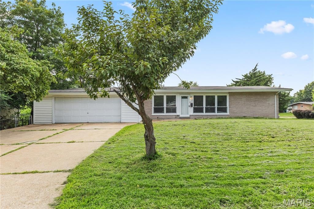 Welcome to this spacious app 1400 square foot 3 bed and 2 bath ranch located just off Shackelford and Mullanphy Road in Florissant. Home is listed as is. Seller has done updates in many areas including the vinyl plank flooring, fresh paint, new lighting, and both main level bathrooms redone. Kitchen has newer cabinets, refrigerator, subway tile and open floor plan to the dining area. Bonus of white washed wood burning fireplace in dining area. Living room is oversized with oversized windows. Bedrooms are good size with ceiling fans and double closet in the primary. Bathrooms nicely refurbished with tile shower and tub backsplash and updated fixtures. Sliding door to patio and backyard. The property is located on a larger corner lot with a good size 2 car garage. Property needs some new windows and work in basement. So  come take a peak as this is a gem waiting for new owners.
