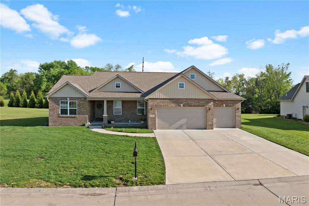 Welcome to this beautifully built 2022 ranch home located in a highly sought-after neighborhood, where modern design meets everyday comfort. Step inside to discover seamless luxury vinyl plank flooring flowing throughout the main level, creating a clean, cohesive feel. The open-concept layout is both functional and inviting, centered around a stunning kitchen featuring gorgeous cabinetry, granite countertops, high-end appliances, and a spacious center island, perfect for entertaining, meal prep, or casual dining. Enjoy the convenience of main floor laundry and a spacious 3-car garage, offering plenty of room for storage and lifestyle needs. The dining area opens to sliding glass doors leading to a covered patio, ideal for relaxing evenings or hosting guests. The primary suite is a true retreat, featuring a bathroom suite and a walk-in closet designed for comfort and organization. Downstairs, the full unfinished basement offers endless possibilities with an egress window and bathroom rough-in already in place, ready for your personal touch and future expansion. Additional upgrades include high-end window blinds throughout, adding both style and convenience.  This home offers the perfect blend of newer construction, thoughtful upgrades, and room to grow, all in a desirable location. Don't miss your opportunity to make it yours!