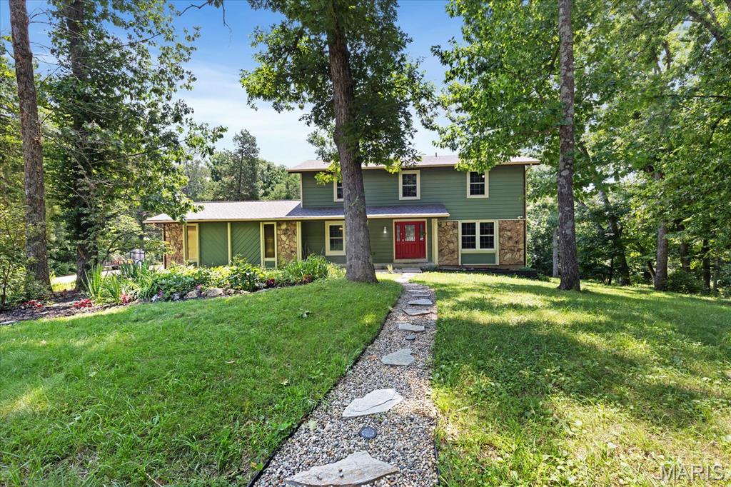 Tucked away at the end of a cul-de-sac and lined by trees on a gorgeous 3 acre lot this lovely, private hideaway is calling you home to a welcoming 2 story gem, Woodworking Shop or She shed, Barn  and pasture.  Enter to ceramic tile entry, coat closet and powder room.  Grand staircase in entry with wood rails and wrought iron balusters.  Large L shaped great room with solid oak floors and wood stove.  Plenty of room for game table or library.  Kitchen has custom cabinets with solid Cherry wood doors and maple shelving cabinets.  Upgraded Austrian Hardware for soft close drawers.  Center island provides additional counter space, and storage.  Gorgeous breakfast nook with large windows allows view of the outside patio and back yard, while providing lots of light.  Freshly painted interior thru out entire home including lower level.  All windows are vinyl, triple paned insulated frame, Certainteed windows on main and 2nd level.   Separate dining for casual or formal get togethers.  Large primary suite with walk-in closet,  sitting room and new carpet.  Second large bedroom has new carpet and can be shared with defined spaces or close off to create additional 4th bedroom.  Partially finished lower level family room with walkout.  Nice sized sleeping room/office with new laminate flooring.  Second oversized wood stove for those chilly evenings.  Walk out to a covered deck from Great Room that overlooks backyard.  Wood working/She Shed building sits back on the lot with front and back decks and stone patio.  Oversized 2 car garage with room for storage or hobbies.   Fruit trees, black raspberry bushes, with area used for vegetable garden.  Stroll through the pasture which leads back to barn.   Property near to Busch wildlife and Weldon Spring Conservation area.  Beautiful place to make many memories.