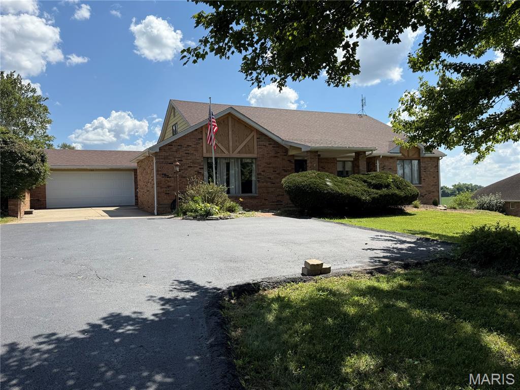 Welcome to this beautifully maintained all-brick home in East Alton! Offering 4 bedrooms and 2 full bathrooms, 1 1/2 bath. this home features an inviting open floor plan designed for both comfortable living and effortless entertaining. The spacious great room boasts a vaulted ceiling, creating a bright and airy atmosphere, while new flooring, which flows throughout the kitchen, dining area, living room and hallway. The well-appointed kitchen opens seamlessly to the main living space, making it perfect for gathering with family and friends. The finished lower level includes a spacious family room, pool room, storage room, craft room, and potential 5th bedroom!. Enjoy outdoor living on the covered back porch overlooking the backyard, farm field, and wooded area. There are No HOA fees! This listing won't last! Roxana School District.