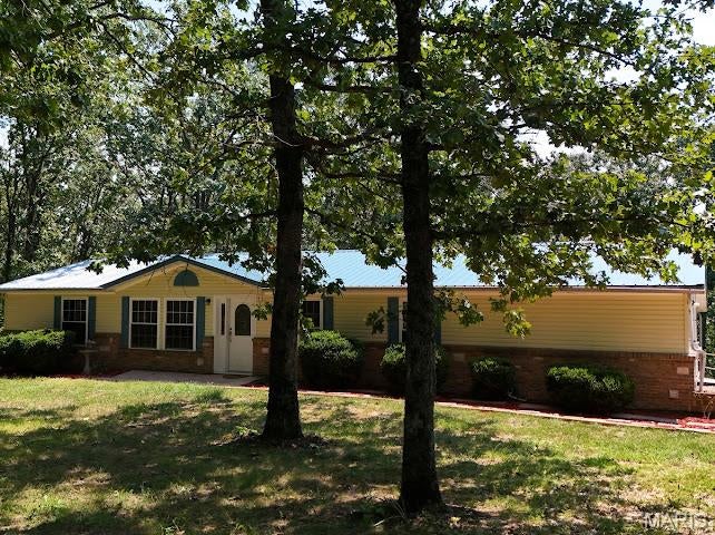 Welcome home to this beautifully maintained 3-bedroom, 2-bath home tucked away at the end of a quiet street on approximately 2+/- acres! With over 1,800 square feet of living space, there’s plenty of room to spread out both inside and out. The open kitchen and dining area creates an inviting space for everyday living and entertaining, while the spacious primary suite offers plenty of room to unwind. Adding even more peace of mind, the home features a metal roof that is only 1 year old! Step outside and enjoy slow mornings or peaceful evenings from the covered back porch overlooking your property. Multiple outbuildings provide additional storage and endless possibilities—whether you're dreaming of a workshop, hobby space, garden, or creating your own homestead. With plenty of usable outdoor space and room to grow, this property offers the country lifestyle you've been looking for while still being conveniently located just minutes from a major highway for an easy commute. Peace, space, and convenience—all wrapped into one well-maintained property!