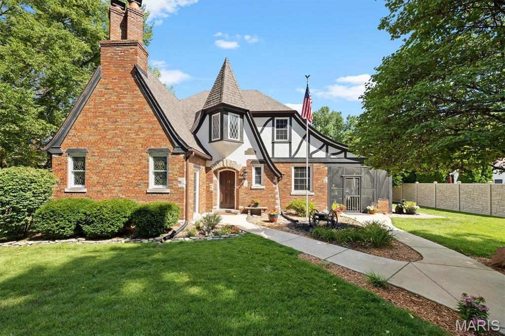 Step into the pages of a storybook at 105 Florence Street, where timeless architecture, rich history, and old-world charm come together to create a home unlike any other. Built in 1932 and nestled in the heart of historic Lebanon, this enchanting residence feels as though it was lifted from the European countryside. Steeply pitched rooflines, decorative half-timbering, rounded archways, wrought iron accents, and stunning hardwood floors create a warm, inviting atmosphere filled with character at every turn. Whether it reminds you of an English cottage or a French chateau, this home invites you to imagine your own story. The dramatic two-story great room is the heart of the home, featuring soaring ceilings, a wood-burning fireplace, beautiful stained-glass windows that bathe the space in colorful natural light, and a charming balcony overlook that adds to the home's open and airy design. The main-level bedroom provides additional comfort and convenience with its own walk-in closet, offering thoughtful storage rarely found in a home of this era. A charming breakfast nook and inviting screened porch blend historic elegance with the comforts of modern living. Upstairs, each of the two bedrooms offers its own private retreat, complete with walk-in closets and doors leading to a balcony overlooking the backyard—the perfect place to enjoy morning coffee, a quiet evening, or the peaceful surroundings of this special property. The sellers have thoughtfully expanded the home's living space by finishing an area of the basement to include an additional bedroom, full bathroom, and a rough-in for a future kitchenette. With its own private entrance, this area offers exceptional potential as a rental for a college student, comfortable multigenerational living suite, private guest retreat, or accommodations for a long-term lodger. Just beyond the living spaces, the attached vintage greenhouse conservatory adds another layer of enchantment. With its weathered charm, beautiful patina, and timeless character, it feels like a hidden garden retreat waiting to be rediscovered. Whether you're a passionate gardener, an artist seeking an inspiring studio, or someone who dreams of thoughtfully restoring its original beauty, this whimsical space offers endless possibilities and perfectly complements the home's storybook appeal. The screened covered patio is a true extension of the home's charm, featuring beautiful wood beams and a cozy, rustic character that creates the perfect setting for morning coffee, afternoon tea, evening cocktails, or gatherings with friends and family. Surrounded by the home's enchanting details, this outdoor retreat offers a peaceful place to relax and enjoy every season. At the rear of the property, a detached three-car garage provides an exceptional bonus for those needing more than just parking. With generous additional space for storage, hobbies, projects, or a workshop, this versatile building offers the kind of flexibility that is increasingly hard to find—perfect for a car enthusiast, craftsman, collector, or anyone who simply appreciates having room to spread out. Located in Lebanon's historic district, this is more than just a home—it's a rare architectural treasure and a piece of local history. Homes like this seldom come to market, offering a unique opportunity to own a residence where craftsmanship, charm, timeless beauty, and modern versatility have endured for generations. Now it's your turn to become part of this remarkable home's story. Write the next chapter while cherishing its rich history and timeless beauty, and create a legacy of your own.