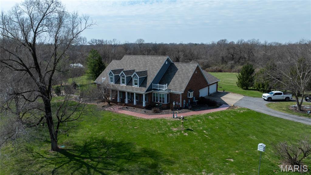 PREVIEW - Friday Night March 27, 2026 - 4pm - 7pm:  Welcome to your private retreat just minutes from Edwardsville and near Fox Creek Golf Course—where luxury, space, and lifestyle come together on 10 breathtaking acres. This stunning 4-bedroom brick home offers nearly 4,800 square feet (total) of beautifully designed living space, perfectly blending elegance with everyday comfort.

From the moment you step inside, you’re greeted by a striking curved staircase and soaring cathedral ceilings that set the tone for the home’s refined character. The main level is designed to impress, featuring a formal dining room, spacious eat-in kitchen, and convenient main floor laundry—ideal for both entertaining and daily living.

The walkout lower level transforms into the ultimate gathering space with a dedicated man cave, game room, family room, additional den, and full bath—creating endless opportunities for hosting, relaxing, and making memories.

Step outside and experience what truly sets this property apart. The backyard is nothing short of a resort-style escape, anchored by a stunning 40,000-gallon heated saltwater pool with a diving board and expansive cool deck. Whether you're hosting summer parties or enjoying a quiet evening, the outdoor kitchen, pool house, and gazebo create an unmatched entertaining experience.

The impressive Morton building with dual covered porches adds even more versatility—perfect for entertaining, hobbies, or simply enjoying the peaceful surroundings. With 10 acres of open space, privacy and possibility are yours to define.

This home is as efficient as it is beautiful, featuring an owned solar system (no lease) with average electric bills of just $60–$70/month, geothermal heating and cooling, and a whole-house generator for peace of mind. Additional highlights include two gas fireplaces, built-in bookcases, walk-in closets, and thoughtful upgrades throughout, including a newer roof and updated pool decking.

Every detail of this property has been carefully maintained and designed for comfort, function, and enjoyment. Whether you're looking for a place to entertain, unwind, or simply enjoy the beauty of country living with city convenience—this home delivers.

This is more than a home… it’s a lifestyle.
