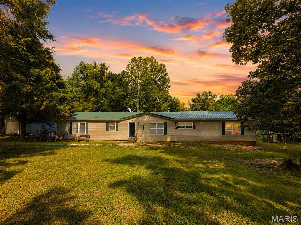 Escape to the peace and privacy of country living with this beautiful affixed manufactured home situated on over 9 acres. A true outdoorsman’s paradise, the property is full of wildlife and offers convenient access to two nearby lakes and Big River access for endless hunting, fishing, and outdoor recreation. Inside, you’ll find a spacious open floor plan, a beautiful sunroom filled with natural light, four generously sized bedrooms, and two full bathrooms. The property also features a variety of fruit trees, including apple, peach, plum, and apricot, along with a large deck, four storage sheds, and endless possibilities for gardening, hobbies, or simply enjoying the outdoors. If you’ve been searching for privacy, space, and country charm, this is the one you’ve been waiting for.