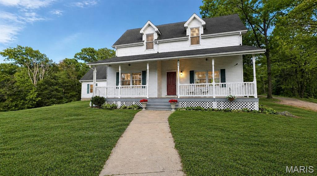 A rare 56 +/- acre offering in Jefferson County combines seclusion, usable ground, and quick access to nearby amenities. Located at the end of a quiet road and just under four minutes from Highway 30, this property delivers a peaceful rural setting while still being an easy drive to the St. Louis area. The land is a well-balanced mix of open pasture and mature timber, highlighted by a stand of pine trees, rolling topography, and attractive views throughout. Ideal for livestock, horses, recreation, or a private country homesite, the acreage provides flexibility for a variety of uses.

The custom home offers approximately 2,369 square feet with four bedrooms and 2.5 bathrooms and has seen significant renovation and expansion. Originally built in 1987 and extensively updated in 2011, the home features a comfortable layout with quality finishes throughout. The living and dining areas showcase recently refinished hardwood floors, while a 12-foot wood ceiling adds warmth and character to the main living space. Additional updates include new carpet in all bedrooms, fresh interior paint, solid oak doors, and spacious closets, making the home truly move-in ready. A covered front porch extends the living space outdoors and provides a quiet place to take in the surrounding countryside.

The property is well equipped for agricultural or equestrian use with open pasture, a barn complete with a large hayloft, and a chicken coop located near the home. Its proximity to Big River Saddle Club adds convenience for horse owners and riding enthusiasts. A separate mobile home, discreetly positioned away from the main residence, offers additional living space that could serve as guest quarters, rental income, or housing for a farmhand or caretaker.

With its combination of acreage, improvements, privacy, and location, this Jefferson County property presents a hard-to-find opportunity. Large tracts with this level of usability and proximity to Highway 30 and the St. Louis region are increasingly uncommon. Whether for a private estate, working farm, equestrian setup, or recreational retreat, this property is well suited to a wide range of uses.