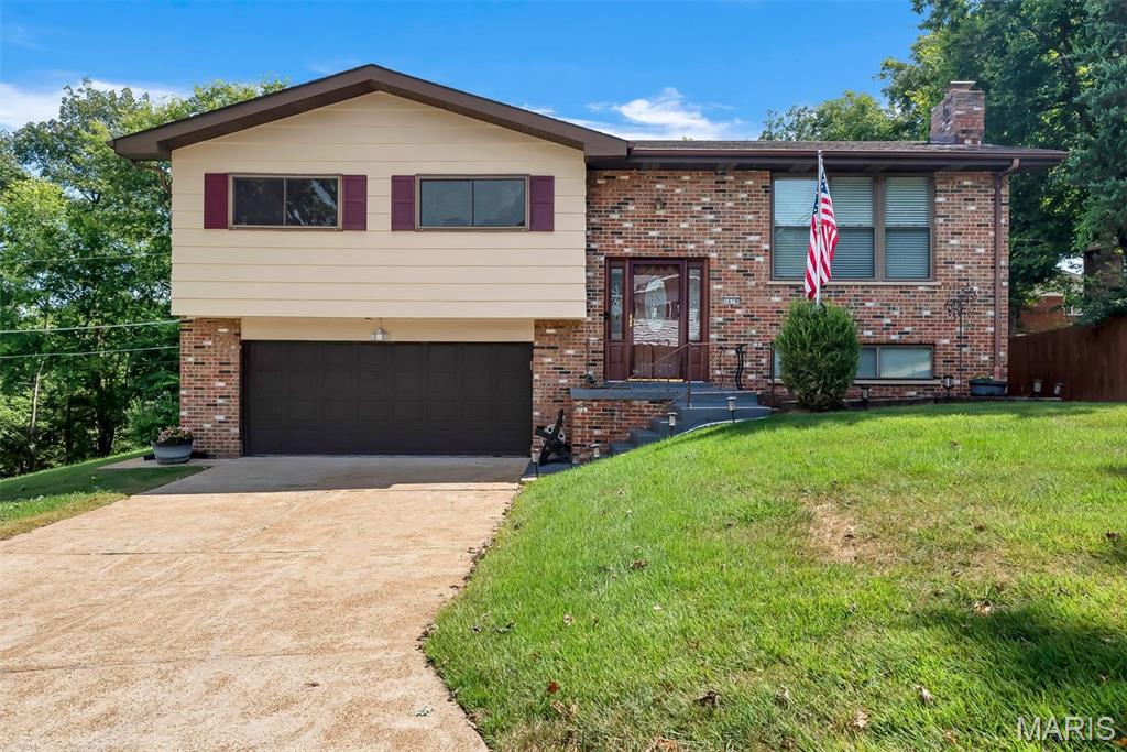 Welcome to 1678 Twin Oaks Drive, a split-foyer 3-bedroom, 2.5-bath home just minutes from I-55 and Highway 141. Enter the front door to an oak staircase leading to the main floor which features the living room with lots of natural light and gleaming hardwood floors.  The kitchen offers plenty of cabinetry, a center island with dishwasher, breakfast bar, pantry, built-in wall oven, smooth-top cooktop, stainless microwave and tile backsplash. A sliding door leads to the wood deck with built-in benches, a great spot for grilling and relaxing. The primary bedroom has a private bath with a glass-enclosed walk-in shower. Two additional bedrooms and a hall bath with a tub/shower completes the main level. The walk-out lower level adds a spacious family room with fireplace, gas logs, plus a half bath, laundry room and a sliding door to the patio. The 2-car garage includes an automatic opener, built-in workbench. Outside, the large backyard is framed by mature trees, a wooded backdrop, and a storage shed.