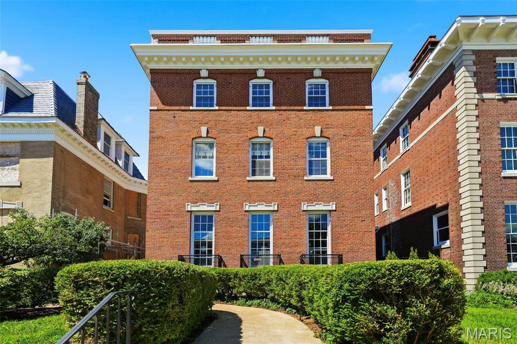 Gracious Federalist-style side-entry mansion in the heart of the Central West End, offering 5,859 sq ft of refined, recently-renovated living space. This stately residence features 7 bedrooms, 4 full baths, and 1 half bath, blending timeless architecture with elegant scale. The 28' x 18' living room impresses with soaring 10-ft ceilings, refinished hardwood floors, grand proportions, and exquisite millwork—ideal for formal entertaining. Rich, refinished hardwood floors, detailed moldings, and multiple fireplaces echo the home's historic charm. The expansive dining room, chef’s kitchen, and breakfast room provide both functionality and style. A luxurious primary suite offers a spa-like bath, ample closet space and convenient home office. Additional bedrooms are generously sized, perfect for family, guests, or office use. The beautifully landscaped lot includes outdoor living spaces for relaxation or entertaining. 2-car garage w/ carriage house apartment updated with paint and new flooring. Ideally situated near dining, cultural institutions, and Forest Park, this architectural gem is a rare CWE offering.