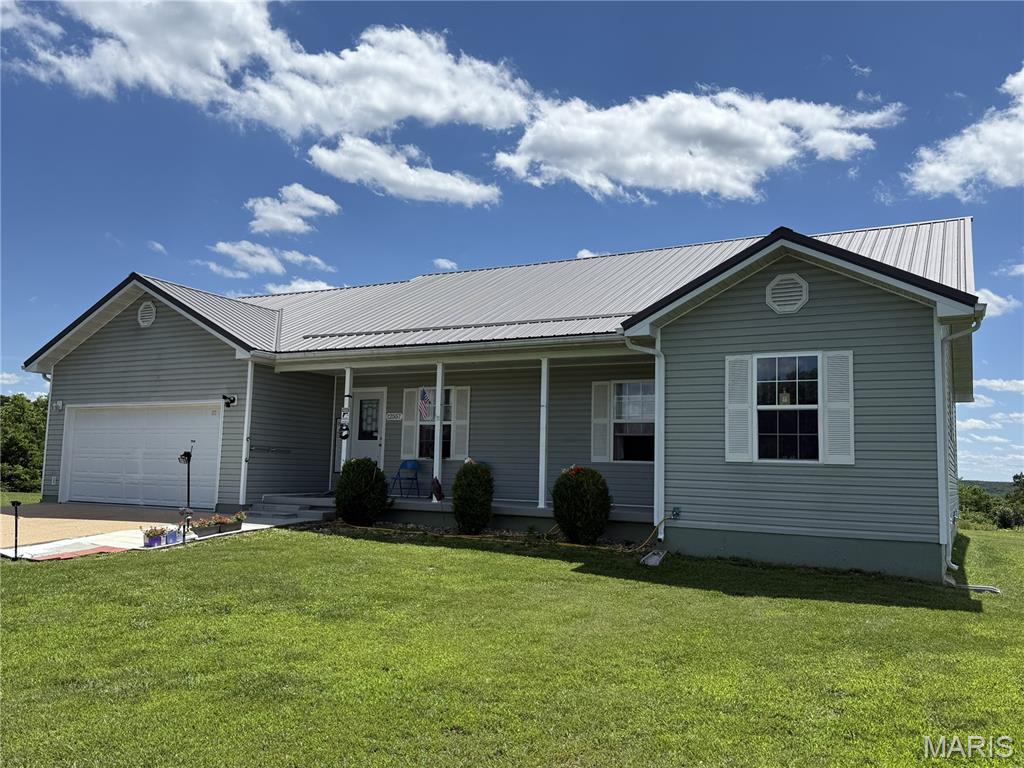 Enjoy peaceful country living in this well-kept 3-bed, 2-bath home on just over an acre with no restrictions. This 1,700 sq ft home offers a large kitchen/dining combo and a brand-new metal roof. Features include a covered front porch, attached garage, and a level yard with open views. A solid country property with space, privacy, and room to make it your own.
