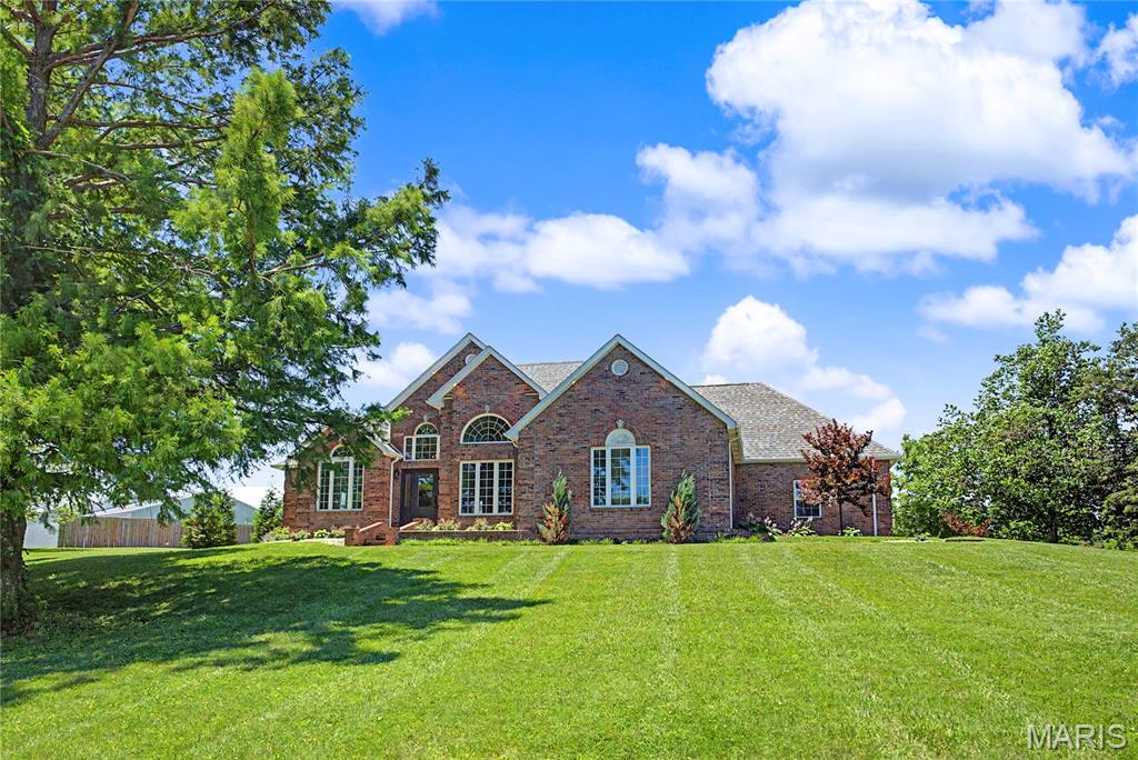 welcome to this beautifully updated country retreat tucked away at the end of a private drive situated on 3.57 acres. The spacious 3 Bedroom home is thoughtfully designed with each bedroom featuring their own private bath, Open concept with a gorgeous kitchen every chef would dream of, Quartz Countertops, Main level laundry, Formal dining room and a Full finished basement boasting a Family room, Bedroom, Full bath, Game room, Office space and a Room for a Gym. All the major components of this home have been recently replaced including Roof, Windows, A/C/Furnace and Water Heater. Outside you'll find endless opportunities to relax and enjoy nature while sitting on your maintenance free deck or fishing in the 1 acre stocked pond filled with bass and bluegill. For the hobbyists there is a 30x40 shop with electricity and additional carport area for additional parking. There is also a whole-house water filtration system. NO COVENANTS OR RESTRICTIONS! You have the freedom within your property to do as you wish.