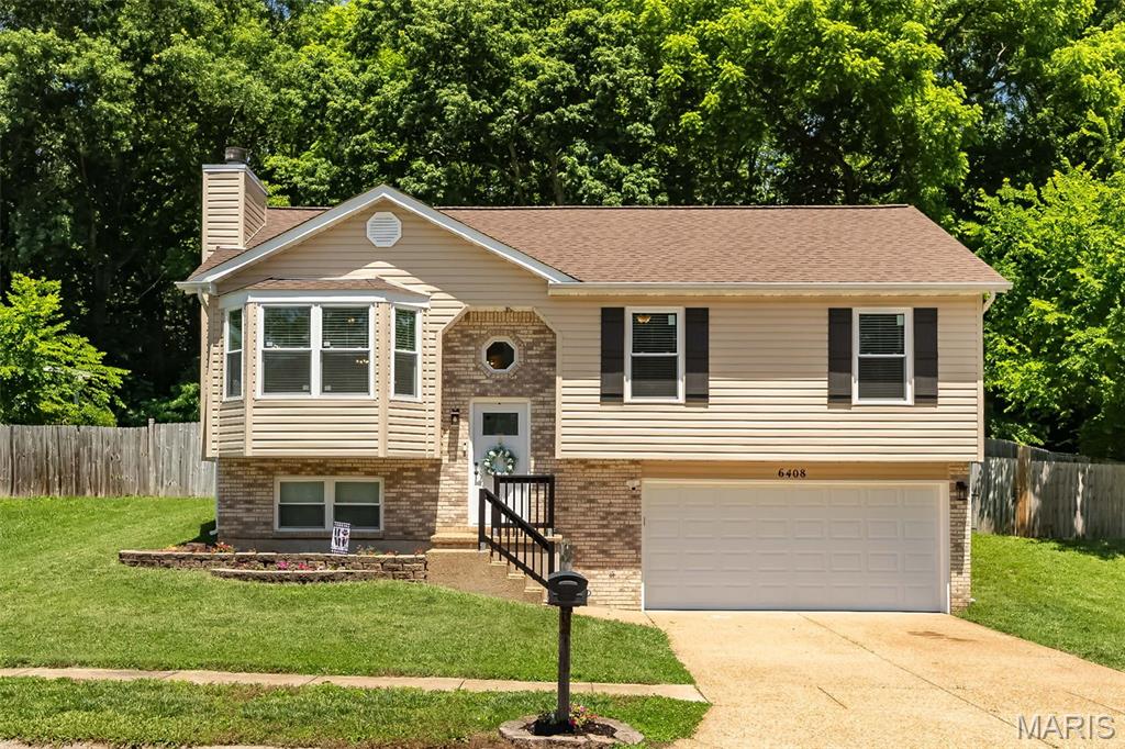 6408 Flagstone Ct. in Imperial, MO is the perfect blend of modern updates and inviting charm! This beautifully refreshed home shines with brand-new windows, stylish siding, eye-catching shutters, and an insulated garage door with opener—all paired with a newer water heater for peace of mind. Step inside to discover durable LVP flooring in the main living areas, while plush carpeting adds a cozy touch to the bedrooms.

The open-concept layout is designed for both comfort and style, featuring a kitchen with freshly painted cabinets, sleek new countertops, large single stainless steel sink with new faucet with hand spray and soap dispenser, updated hardware, and contemporary lighting. The adjoining dining area flows seamlessly onto a spacious deck—ideal for morning coffee or weekend gatherings. Highlights of the great room are the vaulted ceilings, large bay window and warm, wood-burning fireplace, perfect for chilly evenings.

The main level offers three bedrooms, including a serene primary en suite with a walk-in closet and private shower. You’ll also find an updated hall bath and two additional bedrooms, providing flexibility for your needs. Downstairs, the versatile lower level boasts a generous bedroom with its own walk-in closet and shower, making it a great option for a guest suite, family room, or home office.

Outside, this property truly shines. The fully fenced backyard offers both privacy and peace of mind, and it backs to tranquil woods—perfect for enjoying nature right from your own space. Plus, a brand-new shed provides extra storage for all your outdoor essentials.

With all these updates and a move-in-ready condition, this home is ready to welcome you. Don’t wait—your dream home is here at **6408 Flagstone Ct.** Schedule a showing today!